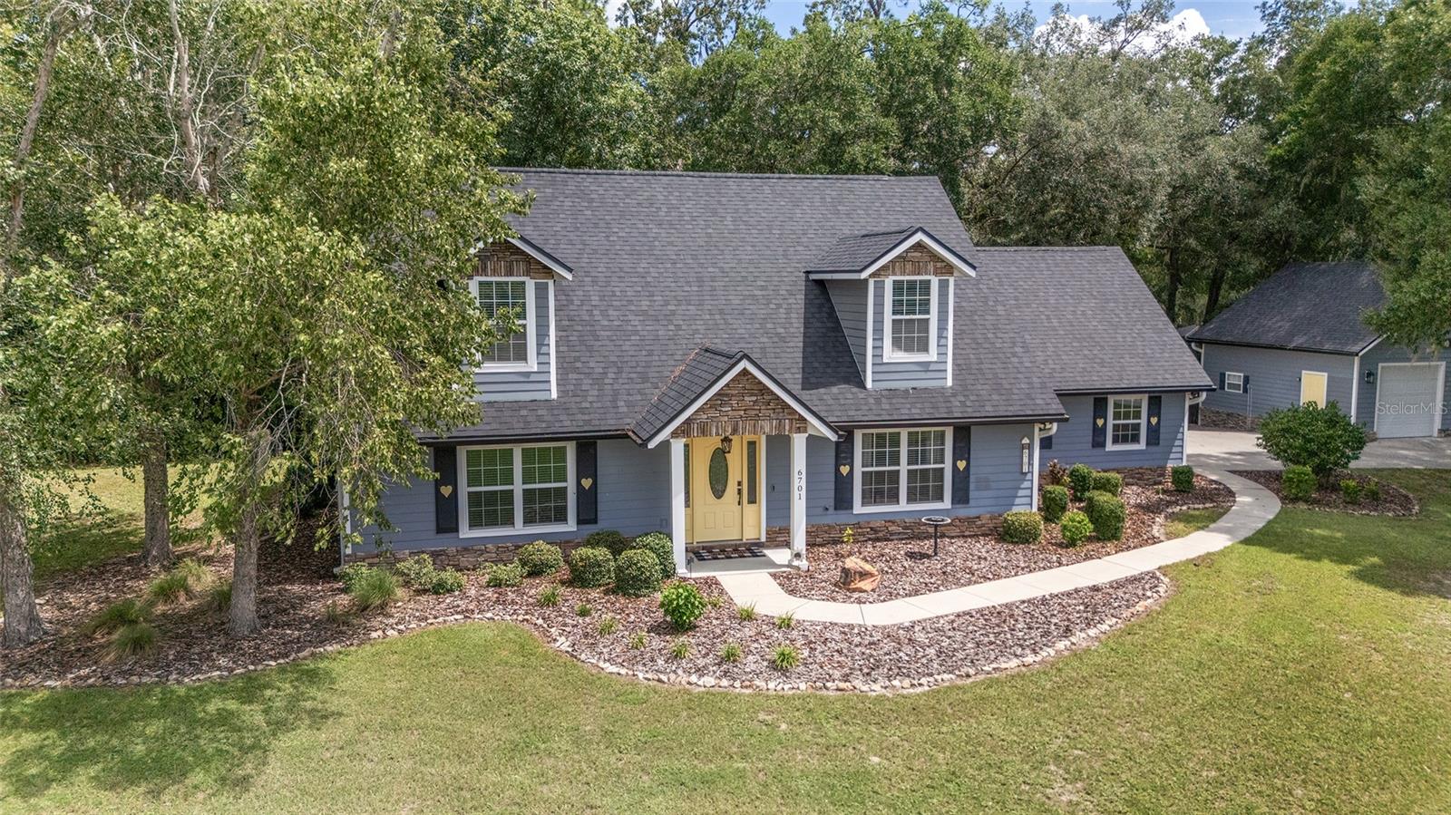 Move-In Ready in Belleview’s Golf Park Neighborhood
Lovingly built and owned by one family, this well-maintained home sits on a full acre in a serene setting with wooded views and a quiet, park-like setting. Intentionally crafted, the two-story design offers a main-floor primary suite with a beautifully tiled walk-in shower, and walk in closet with custom shelving. The main floor also offers a versatile media room that can easily serve as a fourth bedroom or home office. Upstairs, you’ll find two large bedrooms with sunlit dormers, generous walk-in closets, a second full bath, and a bonus storage room—perfect for seasonal items, hobbies, or a dedicated workspace. The kitchen features real wood cabinetry, a classic tiled backsplash, and opens seamlessly to the breakfast nook and dining room, with wooded views. Step outside to a spacious yard, complete with a tree house for play. Enjoy ample parking and storage with both an attached 2-car garage and a detached 2-car garage—ideal for extra vehicles, equipment, or workshop space. Major updates include a new architectural shingle roof (Dec 2024) and a new HVAC system (June 2025) Ideally located just minutes from Ocala, Belleview, and The Villages, with convenient access to shopping, dining, parks, and medical care—this home offers comfort and natural beauty in a setting you’ll be proud to call home.