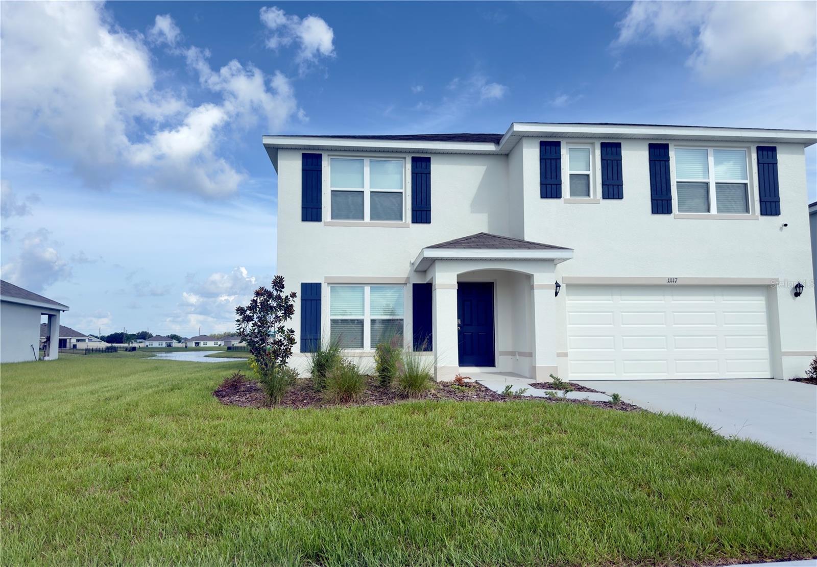 This two-story, all-concrete block constructed home features a spacious open-concept first floor. The modern kitchen overlooks the living and dining areas, and comes fully equipped with a refrigerator, electric range, microwave, and built-in dishwasher. A versatile flex room on the first floor provides space for a home office, playroom, or guest area. You’ll also find a bedroom and full bathroom downstairs, along with a covered outdoor patio over looking a serene lake view.
Upstairs, the expansive primary bedroom offers a peaceful retreat, private bath with his and her sinks & closets. Three additional bedrooms surround a second living area—ideal for family gatherings or a media space. The second floor also includes a third full bathroom and a convenient laundry room with a washer and dryer included. Located in Mandarin Grove and just steps away from the community pool.
With easy access to I-75, and just minutes away from the brand-new Aqua Lagoon Metro, you’ll enjoy seamless connectivity to shopping, dining, and entertainment in a vibrant and growing area close to St Pete, Tampa, Clearwater, Lakewood Ranch and Sarasota.