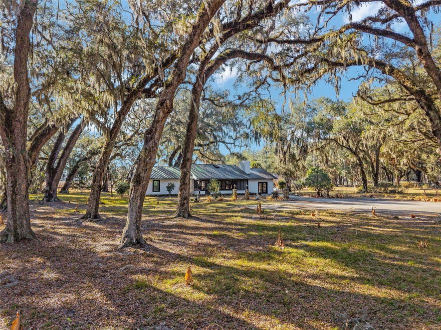 Now Offered at $895,000— A Rare Old Florida Retreat on the Black Sink Prairie

Set within the historic and breathtaking Black Sink Prairie of Citra, this exceptional 21+ acre property offers a rare opportunity to own a private piece of classic Old Florida landscape. With expansive open skies, majestic granddaddy oaks, and rolling pasture, the setting is simply unforgettable. Each day begins with spectacular prairie sunrises and ends with vivid sunsets stretching across the horizon, while the quiet countryside—free from city lights—reveals brilliant star-filled nights in their full glory.

At the center of the property sits a charming 3-bedroom, 2-bath ranch home offering approximately 1,620 square feet of warm and inviting living space. Cathedral ceilings, skylights, rich wood accents, and a striking stone fireplace create a welcoming atmosphere, while large windows frame peaceful views of the surrounding paddocks and countryside.

The property is currently configured as a well-equipped equestrian farm, highlighted by an impressive 175' x 41' concrete center-aisle barn with 16 stalls, including two foaling stalls—an extraordinary structure that would cost well over $1 million to replicate today. The barn also includes tack and feed rooms, spacious wash racks and grooming areas, and a large upstairs loft for hay and storage with exciting potential for future conversion. A studio apartment overlooking the foaling stall adds flexibility for guests, staff, or caretakers.

Additional features include five paddocks with shelter sheds, a regulation-size dressage arena with clay base footing, an additional 8-stall barn, pole barn for equipment, and a large aviary/kennel building with workshop space.

Supporting infrastructure includes an RV pad with water, electric and two wells, three septic systems, generator backup, and many recent roof replacements throughout the property.

While ideal for equestrian pursuits such as boarding, breeding, or training, the true value of this property lies in its extraordinary land, privacy, and natural beauty. The setting lends itself equally well to a private estate, retreat, family compound, or boutique agricultural venture—all surrounded by the timeless serenity of the Black Sink Prairie.
