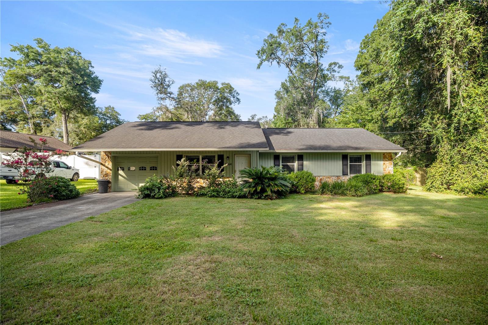Charming & Updated 3/2 Home with Bonus Climate-Controlled Shed in NE Ocala! Welcome to this beautifully maintained 3-bedroom, 2-bathroom home with a 1-car garage, nestled in a quiet and convenient neighborhood in Northeast Ocala. Featuring numerous updates and thoughtful touches throughout, this property is move-in ready and perfect for comfortable Florida living. Step inside to discover updated luxury vinyl plank flooring that flows seamlessly through every room—including the bedrooms and bathrooms—offering both durability and style. The spacious kitchen is a standout, boasting granite countertops, stainless steel appliances, and ample cabinetry. Key upgrades include a newer roof (2018), A/C unit (2018), and a newer water heater, providing peace of mind for years to come. Enjoy your morning coffee or evening unwind in the enclosed porch overlooking a lush, fully fenced backyard—an outdoor oasis filled with mature landscaping, vibrant pink crape myrtle trees, and wild blackberry shrubs. But that’s not all—this property also includes a climate-controlled shed with full electric, water, and heating/air conditioning. Whether you’re seeking a workshop, home office, art studio, or extra storage, this versatile space is a rare find. Located close to medical facilities, shopping, dining, downtown Ocala, and just a short drive to the World Equestrian Center, this home offers both comfort and convenience. Don’t miss out—schedule your private showing today!
