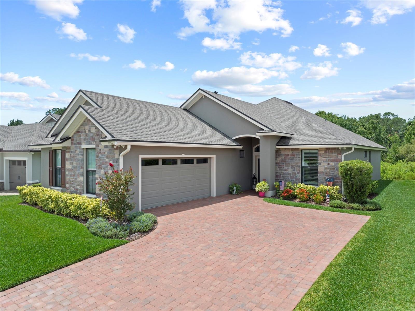 BETTER THAN NEW! This stunning Ernie White-built home is less than 2 years young and sits on a premium, private lot in the beautiful gated, 55+ community of Lake James. With nearly 2,000 sq. ft. of living space, this 2-bedroom, 2-bath home with an office (easily used as a 3rd bedroom) offers comfort, style and a thoughtfully designed layout. From the moment you step inside, you’ll be impressed by the soaring 12-foot ceilings in the main living areas, enhancing the open and airy feel. The remainder of the home features 10-foot ceilings, creating a sense of spacious elegance throughout. The living and dining spaces flow seamlessly into a well-appointed kitchen boasting white cabinetry, quartz countertops, an upgraded stainless steel appliance package and a breakfast bar. Enjoy peaceful views of nature through the French doors in the dinette area, which lead to a screened lanai—perfect for morning coffee or evening relaxation. The primary suite features serene wooded views, an expansive ensuite bath with dual sinks, a large vanity area, a walk-in shower with custom glass door and a huge walk-in closet. Additional highlights include crown molding throughout, 8’ doors with bronze hardware and numerous upgrades completed after purchase—Luxury Vinyl Plank flooring throughout (excluding baths and laundry), Plantation Shutters, rain gutters, and sealed pavers. The oversized side-load garage includes an epoxy-coated floor, and the driveway, lanai and sitting area are beautifully finished with brick pavers. This move-in ready home gives you more time to enjoy the clubhouse, community pool and fitness center. The low-maintenance lifestyle is enhanced by an HOA fee that covers cable TV & internet, lawn care, fertilization & pest control, and irrigation system maintenance.