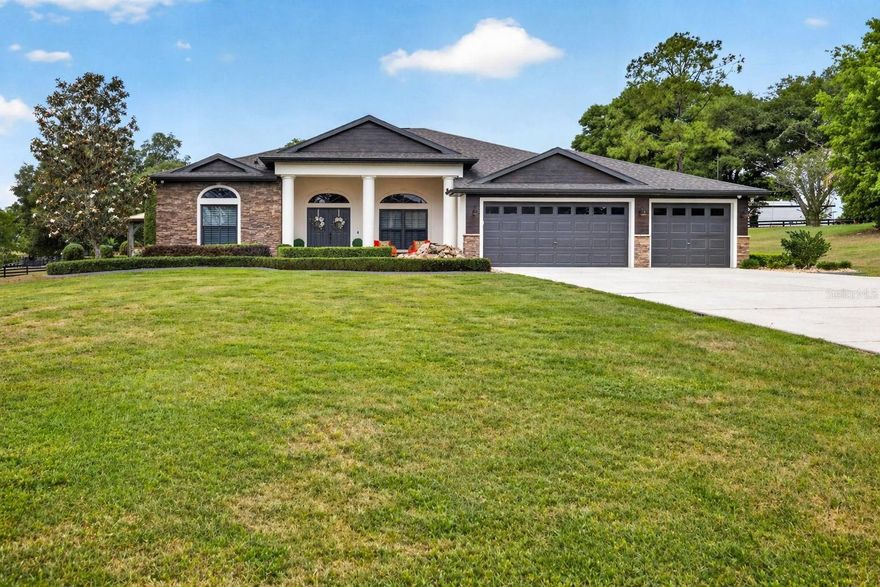Experience luxury living in this stunning remodeled 4-bedroom, 3-bath home situated on a sprawling 1-acre lot. Before you even enter through the impressive double front doors, you’re welcomed by a beautiful water feature and mature landscaping that create an unforgettable first impression. Inside, soaring ceilings, 8-foot doors, and custom stonework throughout the home set a grand and elegant tone. The thoughtful split floor plan offers both privacy and versatility, with separate living and family rooms, a formal dining room, a breakfast nook, and two guest wings, making the home ideal for entertaining, hosting guests, and everyday living. The updated kitchen features granite countertops, stainless steel appliances, and plenty of space for cooking and gathering. The spacious primary suite is a true retreat, offering dual closets, electric shades, custom door shutters, and a beautifully finished ensuite bath with floor-to-ceiling tile, custom cabinetry, soaking tub, walk-in shower, and dual sinks. Plantation shutters on the front windows add timeless style and charm. Step outside to your private backyard oasis featuring a pool, outdoor kitchen with bar seating, firepit, expansive seating areas, and a magnificent view. The outdoor space is also wired for a hot tub and includes extra power outlets, making it perfect for entertaining, relaxing, or hosting special gatherings. Additional highlights include a built-in fireplace with a feature wall in the living room, a flexible office or bonus space connected to the garage/laundry area, and a roof replaced in 2017. This home blends comfort, functionality, and sophistication in a beautiful setting. Don’t miss your chance to make it yours!