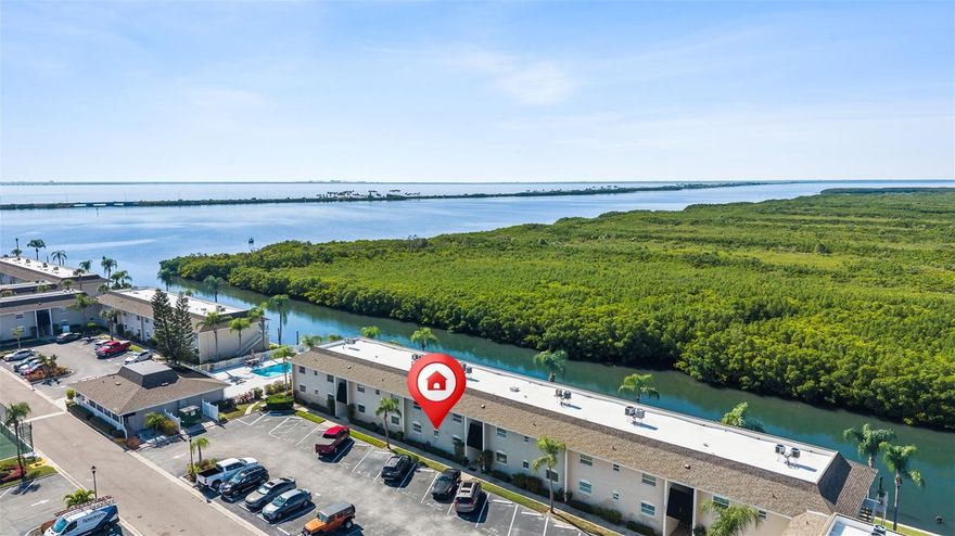 Waterfront living in Tampa takes center stage in this beautifully remodeled 2 bedroom, 1.5 bath condo, offering modern finishes, an open concept layout, and a backyard experience that feels like pure Florida paradise. The main living area flows effortlessly from the kitchen into the dining and living spaces, creating an inviting layout for everyday comfort and entertaining. Updates begin the moment you walk in, including fresh interior paint, new baseboards, updated lighting throughout, and a completely refreshed feel from room to room. The kitchen has been thoughtfully modernized with stone countertops, soft close cabinetry, stainless steel appliances, a newly finished kitchen ceiling, and a breakfast bar that keeps the cook connected with the conversation. It opens seamlessly into the main living area, where a new ceiling fan and two new sliding doors invite natural light and frame the view of the water. Step outside to the covered and screened back porch, newly repainted and overlooking the canal. Morning coffee, evening unwinding, or casting a fishing line from your own backyard all feel effortless here. And when you’re ready for adventure, you are just a short boat ride from Old Tampa Bay. Both bedrooms and bathrooms have been fully refreshed with calming, modern finishes. The full bathroom is a Jack and Jill style shared between the bedrooms and has been completely renovated with a new stone countertop, newly tiled walk-in shower, updated flooring, and a new mirror. One of the bedrooms also houses a full size stackable washer and dryer, thoughtfully included and making laundry day easy and convenient. A newly updated half guest bath sits just off the main living area, perfect for visitors without needing to access the private rooms. Additional updates include a new electric panel, new interior doors throughout including sliding doors, front door, bedroom and closet doors, new toilet, and a recently updated water heater. The community provides even more to enjoy, offering a sparkling pool, tennis/basketball court, a welcoming clubhouse, water sewer and trash included in the fee, and ample guest parking making hosting friends and family a breeze. With stylish upgrades, a serene waterfront view, fantastic amenities, and a convenient location close to local hotspots, this condo is an incredible find, call us today before its gone!