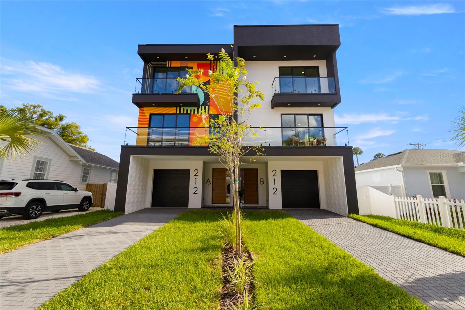 Live in  this brand new 4 bed, 4.5 bath townhome just steps from Armature Works, the Tampa Riverwalk, and all of Downtown’s best dining and entertainment. The first floor includes a one-car garage and a private studio suite with its own entrance, full kitchen, and bath — perfect for guests, in-laws, or a flexible workspace. Upstairs, enjoy an open-concept living area with a sleek moody kitchen, half bath, laundry, balcony, and plenty of room to entertain. The top level features two guest bedrooms with en-suites plus a spacious primary suite with a walk-in closet, moody bathroom, and private balcony. Thoughtfully designed, move-in ready, and in one of Tampa’s most walkable neighborhoods — this home truly has it all.