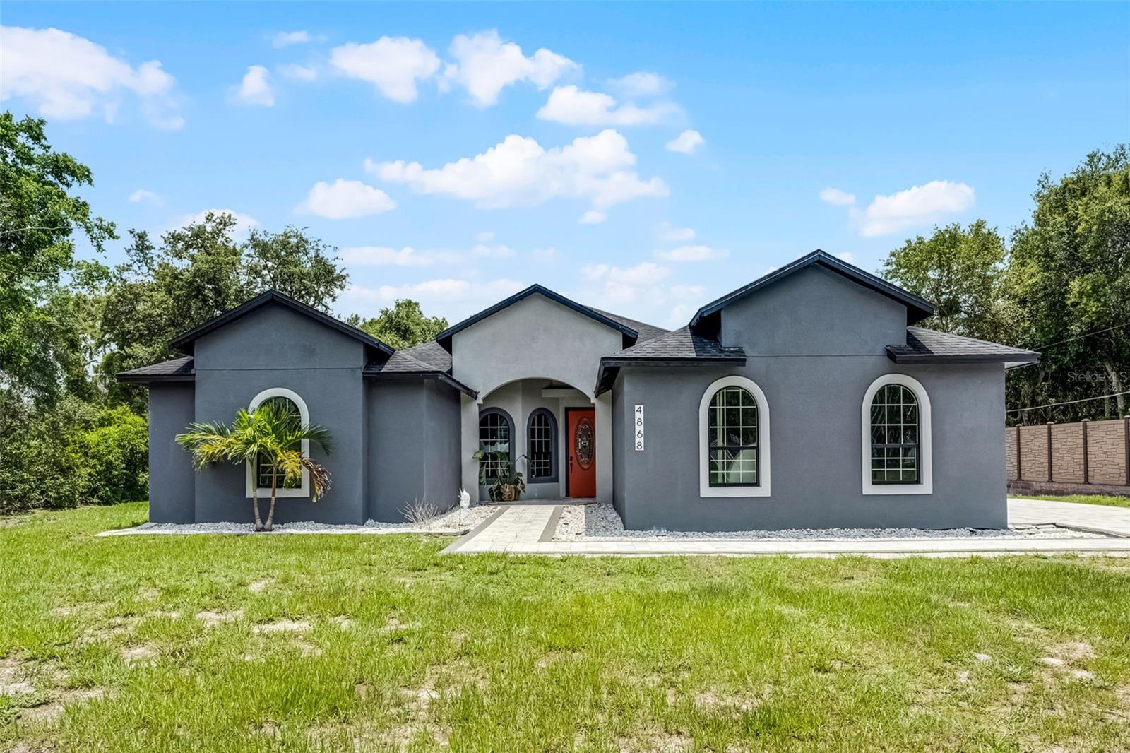 Make no compromises on this fully renovated home, ideally situated in a quiet neighborhood, minutes away from all general conveniences. Built in 2014, and fully renovated in 2023, the seller spared no expenses, creating a open concept masterpiece with designer touches and elevated materials. With large upgraded tile throughout and an abundance of natural light this home blends contemporary finishes with the welcoming comforts of a home. In the heart of the home, an open kitchen, with sleek dual tone cabinets, designer tile backsplash, stylish appliances and natural stone counter, make entertaining friends as well as cozy meals with the family a breeze. In the primary suite is a true retreat, with a wet room in the center, dual sinks and a generous walk-in closet. Two of the guest bedrooms are connected through a spacious Jack & Jill bathroom, while the third guest bedroom offers your guest privacy and comfort. The covered patio creates a perfect space for the indoor/outdoor living, overlooking the pool and water feature. Located just down the street from Chisholm Regional Park and East Lake Toho, with NO HOA and an oversized lot, this home is perfect for all your “toys”. All of this is still only minutes away from the airport, shopping, restaurants and top rated schools.