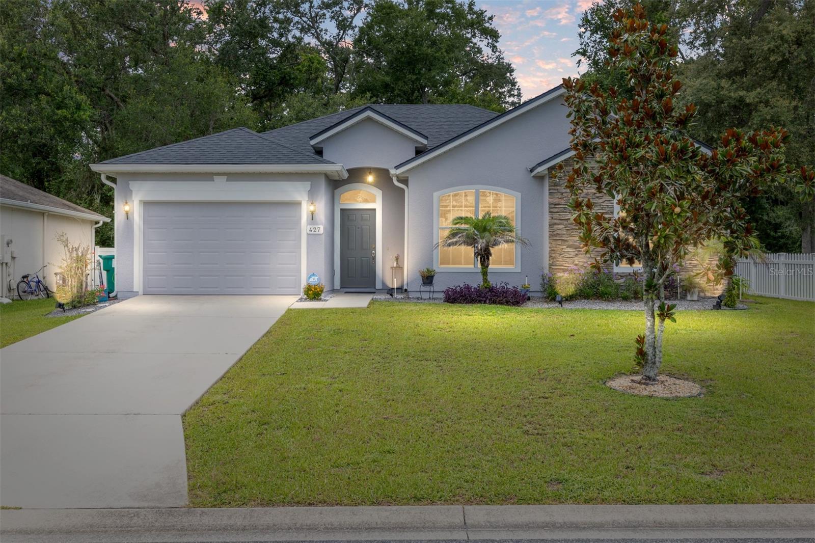 You won't want to miss this cozy home, nestled in the peaceful neighborhood of CIERRA OAKS. This lovely home has many highlights that you'll find irresistible. 3 Bedrooms PLUS DEN (could be a 4th Bedroom with an added closet) – NO HOMES BEHIND with a Wooded AREA for Serene Evenings enjoyed on the rear Patio with the Retractable Sun Setter Awning!! – GREAT LOCATION with easy access to shopping, dining and The Villages ®, FL for work or play!! – Roof is BRAND NEW 2025!! – Freshly Painted Exterior - NO HOA – All-Ages-Neighborhood – NO CARPET, only Laminate, Tile and Luxury Vinyl Plank – Textured 9Ft Walls, and Ceilings – Ceiling Fans – Custom Venetian Slat Blinds & Tray Ceiling in Primary En Suite!! -- Eating Space in the Kitchen with a CLOSET PANTRY and Stainless or Black appliances - Whirlpool Side-by-Side Refrigerator with Water & Ice on Door (10/2021), Kenmore Dishwasher (2007), GE Electric Flat-top Range with Multi-Burners (Dual Element, Warm Zone) Convection Bake (2024) and Samsung Mounted Microwave (12/2012) – Primary En Suite Bathroom has a GARDEN TUB & Step in Tiled Shower & Window – Bedroom 2 & 3 have Ceiling Fans, and Windows and Closets. The Den/Study could be a 4th Bedroom accessed from the Living Room thru a French-Door Entry! – Living Room with Ceiling Fan & and Dining Room with a 9Ft 3-panel Glass Slider with view of the Wooded area! .. SUPER Location – Don miss out on this Amazing Home in Cierra Oaks of Lady Lake!