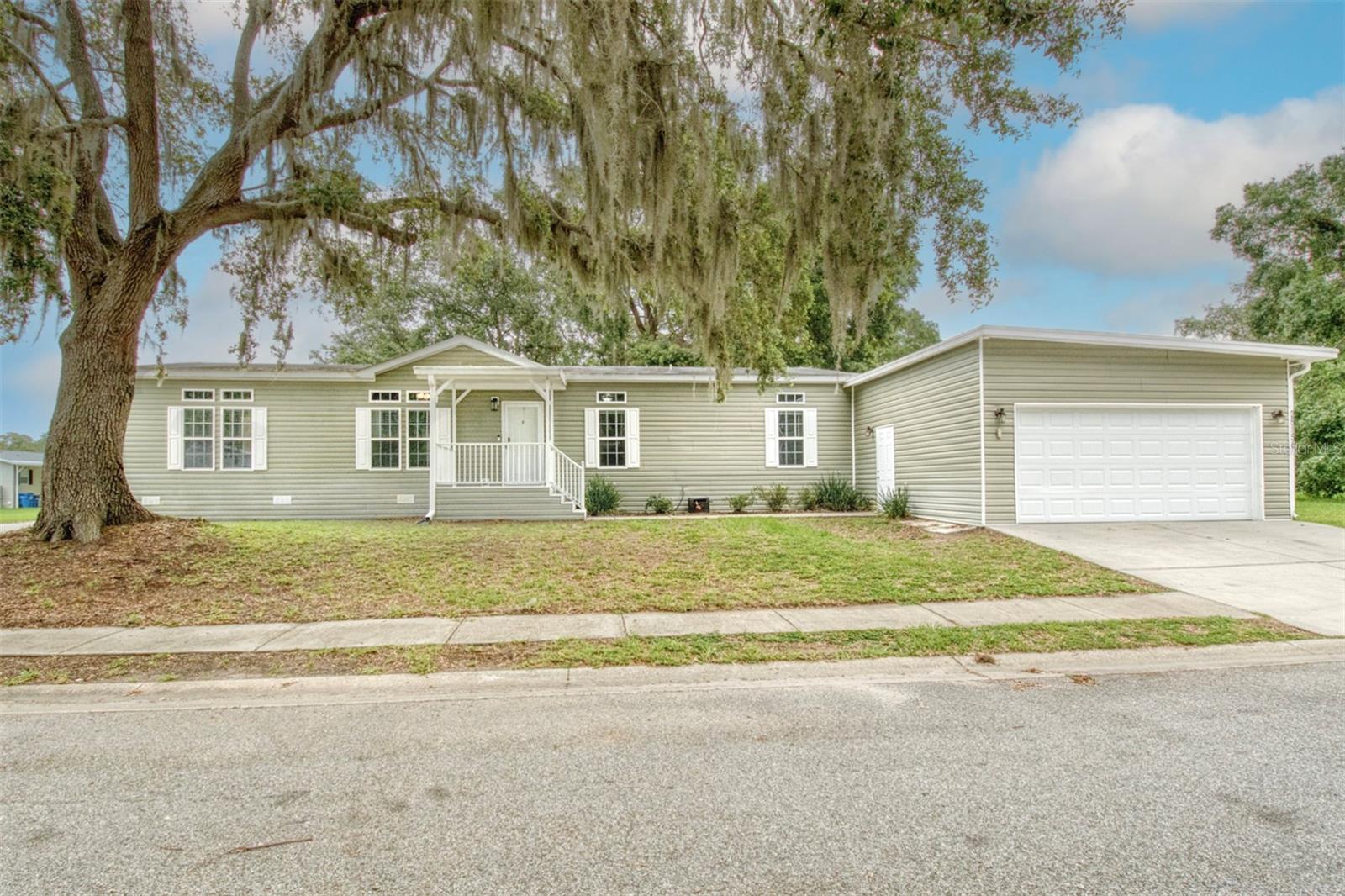 This property is eligible for 100% Financing through USDA! If you seek a home with luxury finishes in a quiet neighborhood, then welcome home. This 3-bed 2-bath home is the former model home for the development of The Meadows and is filled with upgrades. This is the only home in the neighborhood offering a 2-car garage and two connected screened-in patios. Double-pane windows allow natural light to pour into the home while keeping the home better insulated. Enter the home, and your eyes are drawn to the luxury vinyl floors, then up to the high ceilings where crown molding and tray ceilings frame the space. The large kitchen offers stainless steel appliances and a raised sink with a beautiful window overlooking green space. Crown-molded cabinets and a pantry provide plenty of storage, and the kitchen island looks out on the living room. The large dining space allows you to host family gatherings and holiday events, and the 2nd living space is perfect for a 2nd seating area or desk/office space. The large primary suite has floor space for a king-size bed and wall space for multiple dressers. The primary bath offers a dual vanity with a large soaking tub, a separate shower, and a large walk-in closet. The indoor laundry room is perfectly tucked away near the 2nd and 3rd bedrooms. Outside, the screened-in patio flanks the back and side of the house and is directly connected to the garage. The garage is large enough and tall enough for plenty of storage and parking for 2 cars. The community pool is available when you want it. Come and make this beautiful house your own and feel the calm of living here.
