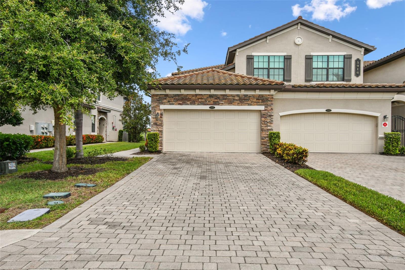 This beautiful end-unit Coach home offers breathtaking views of the 18th fairway at LakeWood National Golf and Country Club. Imagine a life of leisure and convenience within this stunning golf and country club community. This maintenance-free home features crown molding, 3 bedrooms, 2 bathrooms, 2 car garage, impact windows/slider, and provides a spacious open floor plan with elegant tile flooring in the main living areas. The upgraded kitchen, complete with a large center island, is perfect for entertaining. You'll also appreciate the upgraded neutral-toned laminate flooring in the bedrooms, designed with modern living in mind. The oversized primary suite is a true retreat, offering picturesque lake and golf views and direct access to the lanai complete with new flooring – the perfect spot to unwind. Residents of Lakewood National enjoy the added security of a 24-hour manned gate, and a vibrant social scene with numerous events and activities. The resort-style amenities are exceptional, including multiple swimming pools, a tiki bar, tennis and pickleball courts, a fitness center, bocce ball, and conference and event spaces. This is a truly remarkable opportunity to embrace a luxurious lifestyle in the lush natural beauty of Lakewood National Golf and Country Club. Dishwasher and Washer 2024, new paint interior.