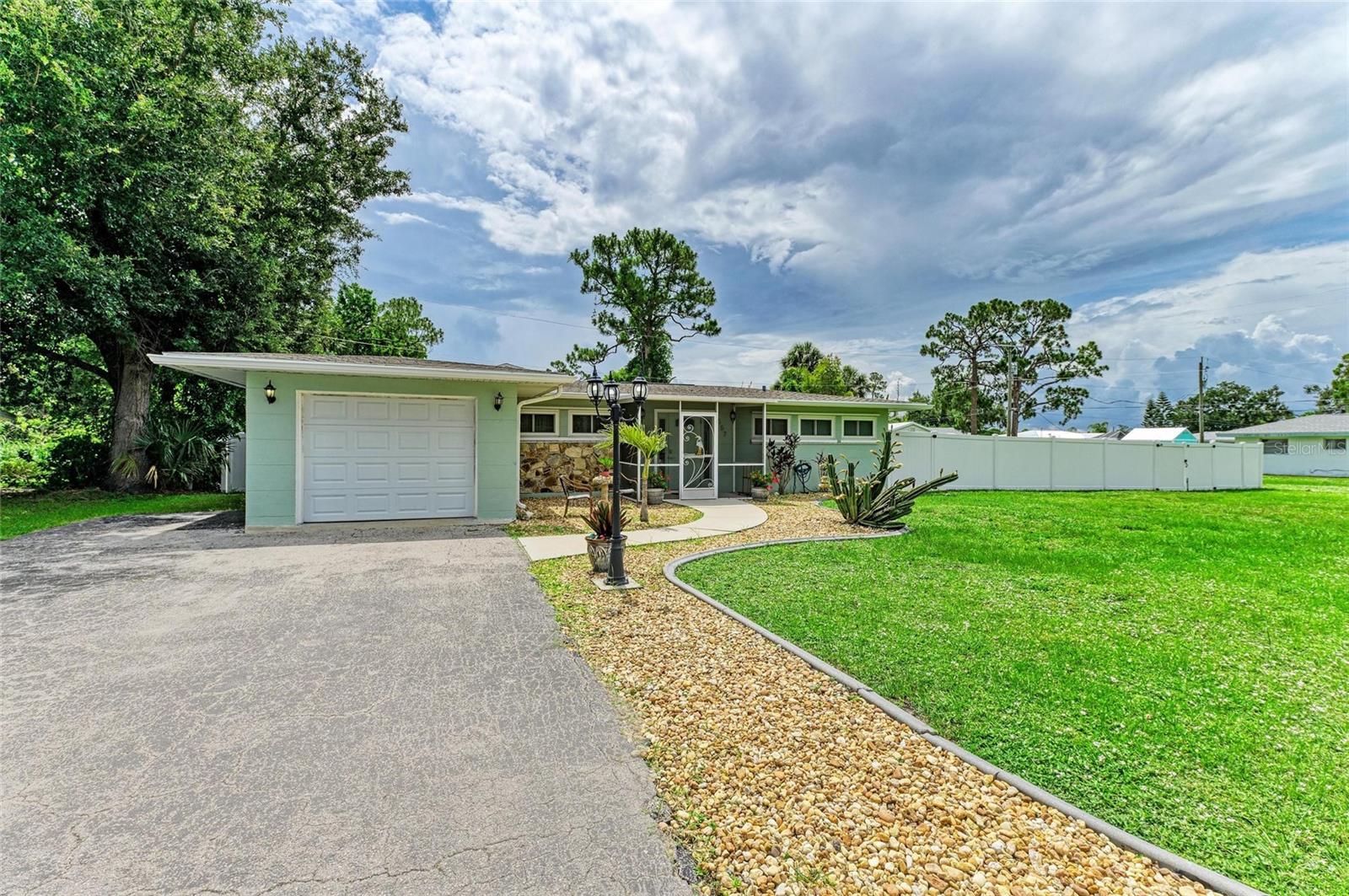 Are you looking for NO HOA so you can park your business vehicles, RV, or boat? Need to build an in-law suite/cottage? This move-in ready 3 bedroom, 2 bath ranch home on 1/3 acres has MANY POSSIBILITIES!!! The master bedroom is spacious with a large walk in shower . The split floor plan has two bedrooms on the opposite end of the home and a separate bathroom. The kitchen features wood cabinets, granite countertops and stainless steel appliances . There's even a pass through serving window to the lanai from the kitchen. Professionally cleaned and freshly painted interior, it is ready for a new owner. New ROOF and new heated pool/paver deck/lanai and cage installed in 2024. NEW PVC fence (single and double gate entry) to let your pets roam free. There is a large storage shed for yard equipment or use as a workshop. The garage has been divided with a laundry room and separate storage. It can be easily converted back into a single car garage. No hassle with a well or septic maintenance. This home is on both city water and sewer. There is a combination of impact glass windows and galvanized hurricane panels for the home. Come check out this double lot property with close access to everyday needs. Nearby access to public boat ramps. Schedule your showing today!