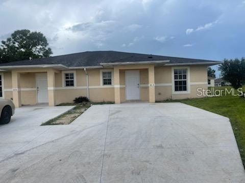 Updated 3/2 half of a duplex with tile floors throughout, an open kitchen and living area, private washer/dryer in the unit, central ac, screened patio, and large driveway.