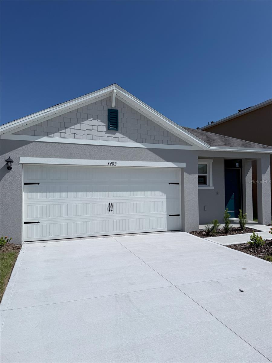 This single-story home is located in Villamar in Winter Haven, Florida.
Inside this 3-bedroom, 2-bathroom home, you'll find 1,500 square feet of comfortable living space. The living room is an open concept, where the kitchen, family room, and dining room seamlessly blend into a space perfect for daily living and entertaining. Relax on the covered deck overlooking your backyard. The kitchen features granite countertops, stainless steel appliances, and a walk-in pantry. You'll never be too far from the action with the living and dining areas right there. Each bedroom will have carpeted floors and a closet in each room. Whether these rooms become bedrooms, offices, or other additional rooms, comfort is guaranteed. The master bedroom, located at the back of the home, has its own bathroom with a walk-in closet and all the space you need to get ready. Like all homes in Villamar, it includes concrete blocks and smart home technology, allowing you to control your home at any time with your smart device, whether you're near or far. Contact us today if you want to make this house your next home. The owner does not allow pets and does not allow smoking inside the house. Lawn maintenance is included in the rent.