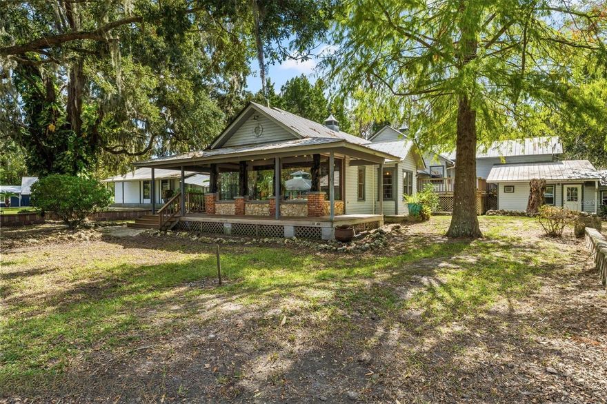 CREATIVITY WELCOMED!  HAVE AN IDEA, PRESENT IT!  Welcome to a truly incredible treasure in the heart of Old Homosassa, where history, charm, and opportunity come together! This exceptional property is approved for both commercial and residential uses, making it a perfect match for those seeking a dynamic live-work lifestyle or a unique investment opportunity. The main structure boasts 900 sq. ft. of open retail space, complete with wide bay windows that flood the area with natural light, stunning heart pine wood floors, and a welcoming wraparound front porch. Formerly a thriving art gallery, this space is brimming with possibilities—imagine it as a cozy coffee shop, a creative art studio, a tackle and fly shop, or even a short-term rental. Connected to the retail space is a spacious 3-bedroom, 1-bathroom residence with a versatile loft, a private entrance, and backyard access. With ample storage and plenty of charm, this attached living area is perfect for an on-site owner, rental income, or additional workspace. The 60'X30' warehouse offers tons of functionality and has HUGE use potential. It features a roll-up garage door, two bathrooms, two retail-style front windows, side load entry, and an inviting covered front porch. Elevated construction overlooks a beautiful park-like front lawn, creating a picturesque setting for any use. Perfect for a workshop, retail space, work/business office space, art studio, brewery, storage... Perfectly situated on the corner is an existing ice cream shop with a very happy paying tenant who would like to stay after the sale. This small but versatile building could go in many directions if new owner wishes. Flexibility is the name of the game with this stand alone building, currently best served as a 1/1 studio apartment, this little charmer with fantastic views would thrive as a short term rental, small retail shop, office, or additional storage. There is an abundance of detached storage on the property, including one that has served as past living space! the current owner has chosen to preserve several features of the compound that have long been considered treasures of the area. The front lawn has been host to many community gatherings, social events, and festivals. The original brick fence walls still stand strong and add that complementary ascetic to the preserved outdoor art features, breathtaking oak trees, and original designer accents. The lawn can be changed to parking under the new owners needed/intended use. This isn't a property that can be easily and appropriately described in a listing description, it has to be seen and felt in person to discover the true wonder and inspiration of what could be! Endless potential, endless possibilities, the only thing missing, is your vision.