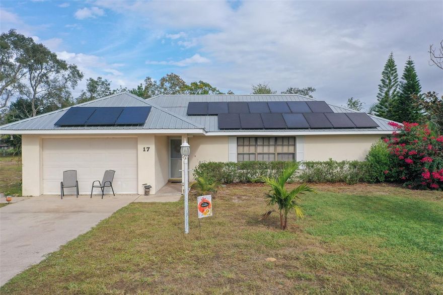 Presenting a genuine opportunity in the "Caladium Capital of the World," this charming Lake Placid home seamlessly blends Florida comfort with smart, efficient living. This property features an existing solar panel system and a durable metal roof, providing the potential for future cost savings and a modern, sustainable lifestyle. The interior boasts a bright, welcoming ambiance with desirable vaulted ceilings over the main living area and attractive wood-look laminate flooring throughout, creating a cohesive, low-maintenance environment. The well-appointed kitchen features classic white cabinetry, stainless steel appliances, and a generous U-shaped breakfast bar perfect for casual dining and entertaining.  Step outside to the rear screened patio—an enclosed haven that overlooks the private, fenced yard complete with mature shade trees and a vast lawn, offering the perfect secluded retreat for enjoying the beautiful Florida weather. Homeowners also have access to Lake Henry, an idyllic spot for fishing enthusiasts and nature lovers alike, along with a nearby park that invites leisurely strolls or picnics under the sun. Complete with a two-car garage and a fantastic location, this property is a must-see for anyone seeking an energy-minded home with excellent curb appeal. Schedule your private showing today, and let the charm of this home sweep you off your feet!