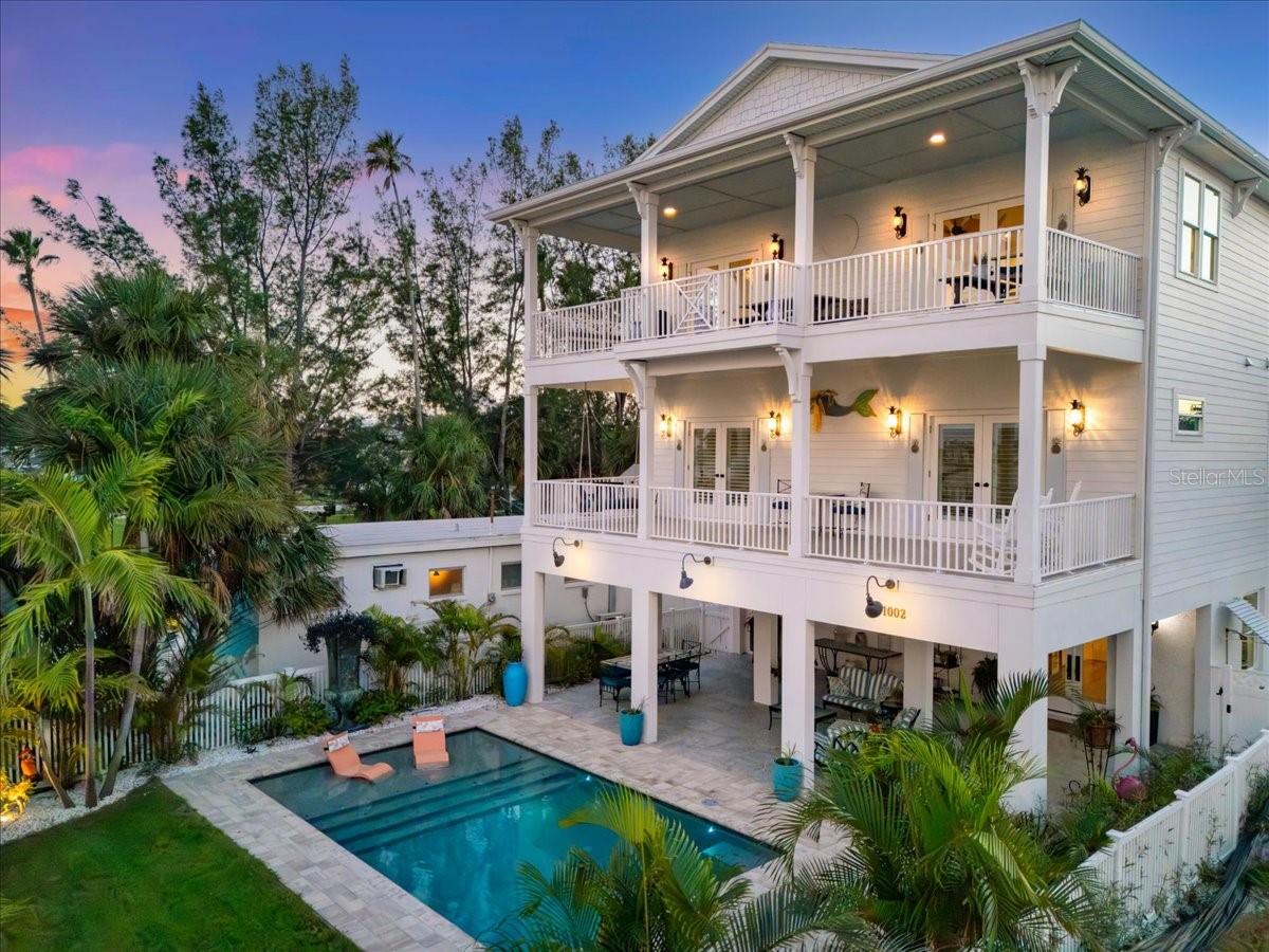 Welcome Home!
WHY WAIT Years To Design, Permit, and Build When You Can Step Right Into
Water View Perfection?
1002 Pass A Grille Way sits in the most coveted stretch of St Pete Beach:
Pass-A-Grille. Dreamers wish upon the stars for this home’s location. A
community where neighbors still gather on 8th Ave, stroll to curated shops,
and share cocktails at local favorites just blocks away.
This 2022 raised beauty has it all—4 bedrooms, 3.5 baths, an elevator, and
nearly 3,000 sq. ft. of living space (over 5,000 including patios).
Toes in the sand, a dip in the Gulf—your day has begun! In less than five
minutes you’re back at your private outdoor shower, rinsing off, and
heading upstairs to the 3rd floor where the magic happens. This is the
heart of the home and the lifestyle that you’ve been craving!
The wide-open living space leads to French doors showcasing a front row
view of daily waterfront theater: dolphins at play, sailboats drifting by,
rainbows arching across the bay, and sunsets that glow long after the last
sip of your cocktail. Your 'bay' view surpasses just an intracoastal look, this expansive view of the Pass-A-Grille Channel is at the mouth of the Boca Ciega Bay connecting it to the Gulf of Mexico. Anchored by a custom marble gas fireplace, the great
room spills into a chef’s kitchen that absolutely steals the spotlight—hello
French La Cornue gas range, custom cabinetry, sleek granite
island, and a show-stopping Portuguese tile backsplash.
Through an arched entry, the “secret second kitchen” (yes, oversized
pantry but so much more) gives you a second fridge, second dishwasher,
another sink, granite counters, and gadget-ready shelving. Dinner parties,
cookie marathons, cocktail prep—this space makes you look like a hosting
pro.
Downstairs, the primary suite is a retreat you’ll never want to leave - French
doors open to a private balcony overlooking the pool, custom closets,
ensuite bathroom with dual vanities, and oversized shower (big enough for
you, your chaise lounge and your daydreams). This floor also offers three
additional bedrooms each with their own personality, custom finishes, and
storage galore. Two additional bathrooms are on this floor (one of them
ensuite), and a conveniently located laundry room to keep life effortless.
Stairs or elevator down to the garden level, step outside, and the vacation
vibe is real! A sparkling pool with a sun shelf, new pool equipment and
lush landscaping on irrigation—all wrapped in fresh vinyl fencing— it’s your
own tropical hideaway.
The details that make it worry-free?
A two-car hurricane rated garage door,
hurricane-impact windows and doors,
modern day building materials, specific designer tile and lighting,
a whole-house water filtration system, and a
Generac gas generator that keeps the party (and
the AC) going even if the power does not.
This home is more than move-in ready—
it’s an invitation to step into the waterfront lifestyle right now.
Bring the champagne.
You Are Home...