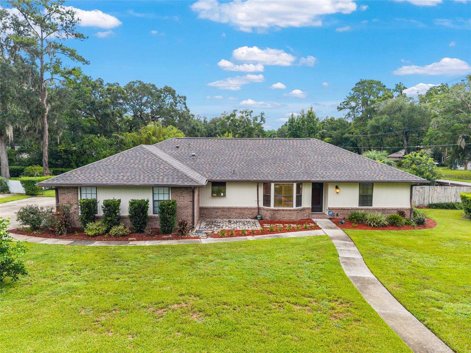 This is a beautifully maintained 3-bedroom, 2-bathroom home nestled on nearly half an acre in one of Northwest Gainesville’s most desirable neighborhoods. Built in 1988 and spanning 1,852 square feet, with new appliances, water heater and a new roof, this charming residence offers a thoughtfully designed split floor plan with generous living spaces, including a large dining area perfect for gatherings and a cozy wood-burning fireplace that anchors the main living room. The home also features a whole-house sound system, adding a modern touch to everyday living. Step outside to your private oasis where a fully enclosed swimming pool is surrounded by a lush landscape, including mature trees, banana and blueberry bushes, and even rain catchment barrels for sustainable gardening. A storage shed with a roll-up door offers additional functionality, and the expansive yard provides both beauty and privacy. Located close to Hidden Oak Elementary and Fort Clarke Middle School, and just minutes from local parks, shopping, and major roads, this property combines comfort, convenience, and character.