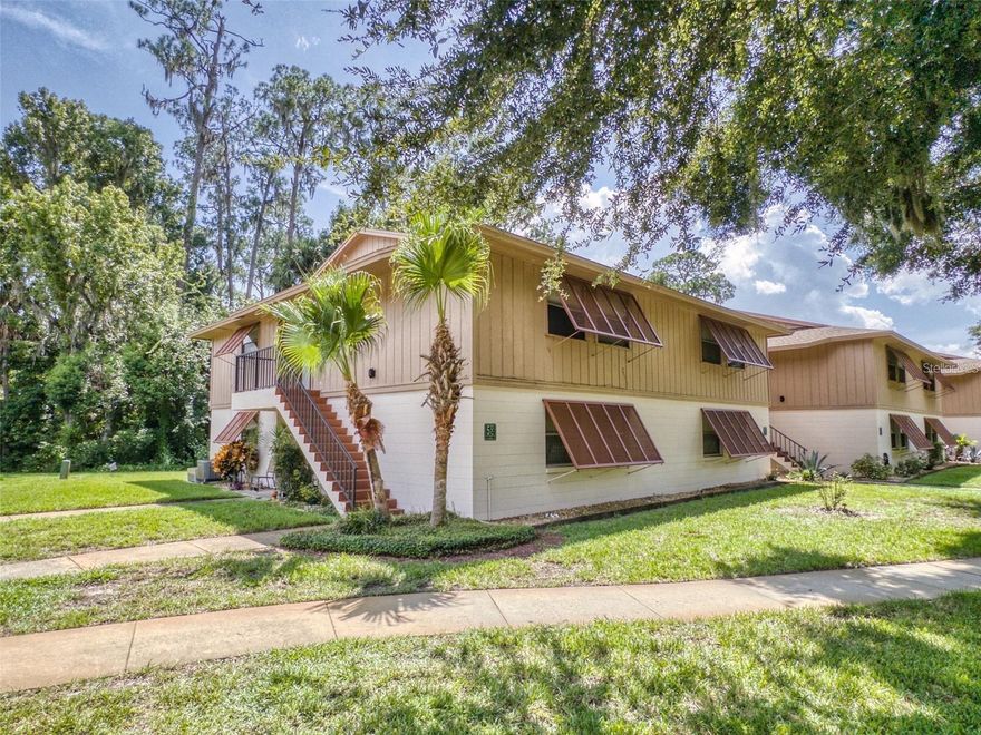 FANTASTIC LOCATION!! Only minutes to I-4, the Orlando metro Area, and the beaches.  Walking distance to Publix, Central Florida Trail, Lake Monroe, and more!  Well kept community right on the St. Johns River with a community pool and tennis courts and walking distance to the public boat ramp across the street from the river.  Nice upstairs unit with a new AC unit installed in 2021 and a brand new range and refrigerator.  Also includes a brand new stackable washer and dryer and is considered to be in one of the nicer locations of the complex with a very private and tropical back view off the large screened porch.