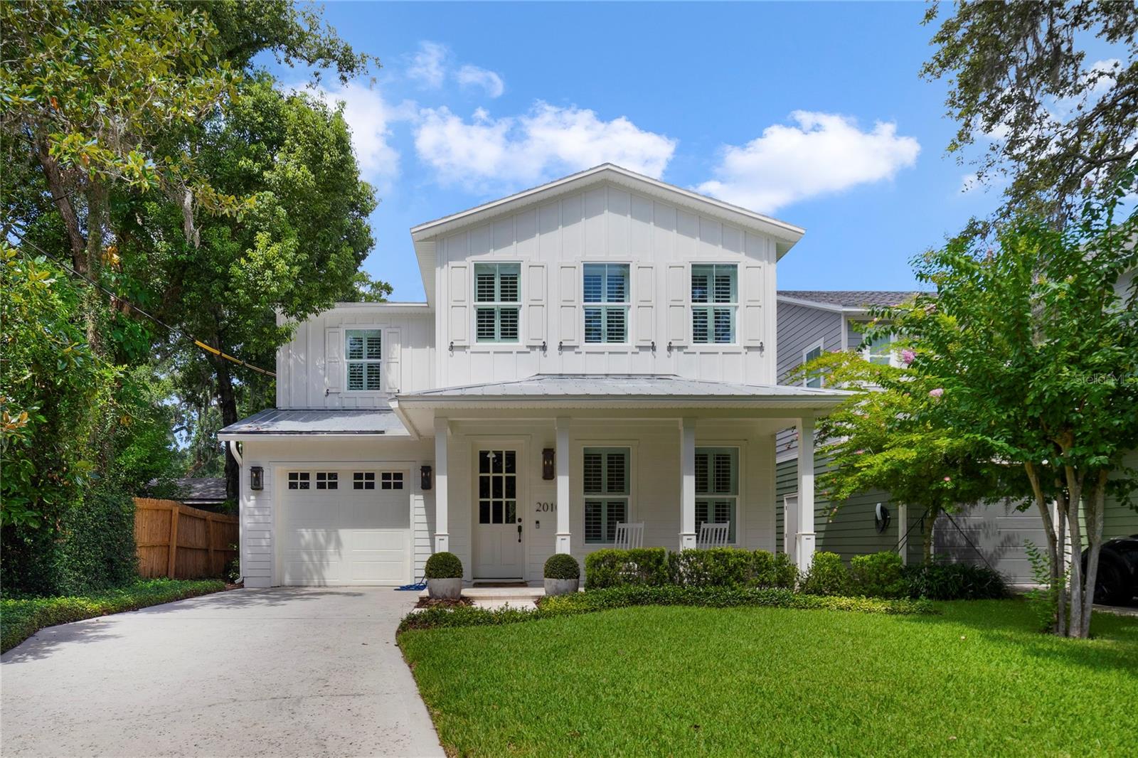 Nestled in one of College Park's Premier Streets.... Welcome to this 4 bedroom 3 full bath home. Nearly new from its 2015 construction, this home has many notable features. One of these is the transitional elevation that boasts 3 solid copper lanterns. A Buckhead styled front door offers bright eastern divided light within mullioned glass. The covered front porch has updated solid stone adding a nice touch. Inside a grand foyer greets you with wood flooring. The kitchen features a large island with seating as you prepare many delicious meals. Stainless steel appliances and a French door refrigerator lends an upscale feel. The family room is quite cozy with hardwood flooring and solid brass wall mounted lighting. The dinette, adjacent, is just the right size for family gatherings. There is a generous 4 panel slider that opens to the covered lanai. The slatted wood ceiling and ceiling fans add a coastal feel to this space. Newly installed permanent turf is bright and cheerful, and you never have to hear the sound of lawn equipment again!! Back inside and upstairs a loft offers space for homework or board games. The primary suite is oversized and has two separate closets. A nook in the corner is available for a desk and laptop. Connected is the primary bath. A soaking tub gives that spa-like feel as does the oversized shower with designer tile. Down the hall there are two more bedrooms, each with generous closets. One of the guest rooms is en-suite. Laundry is up and offers much convenience on this level. There is an additional en-suite down for out-of-town guests for a no stair option. The garage is very deep in size and has generous space. This College Park home is available Now and is ready for its new owners.... make your appointment today!!
