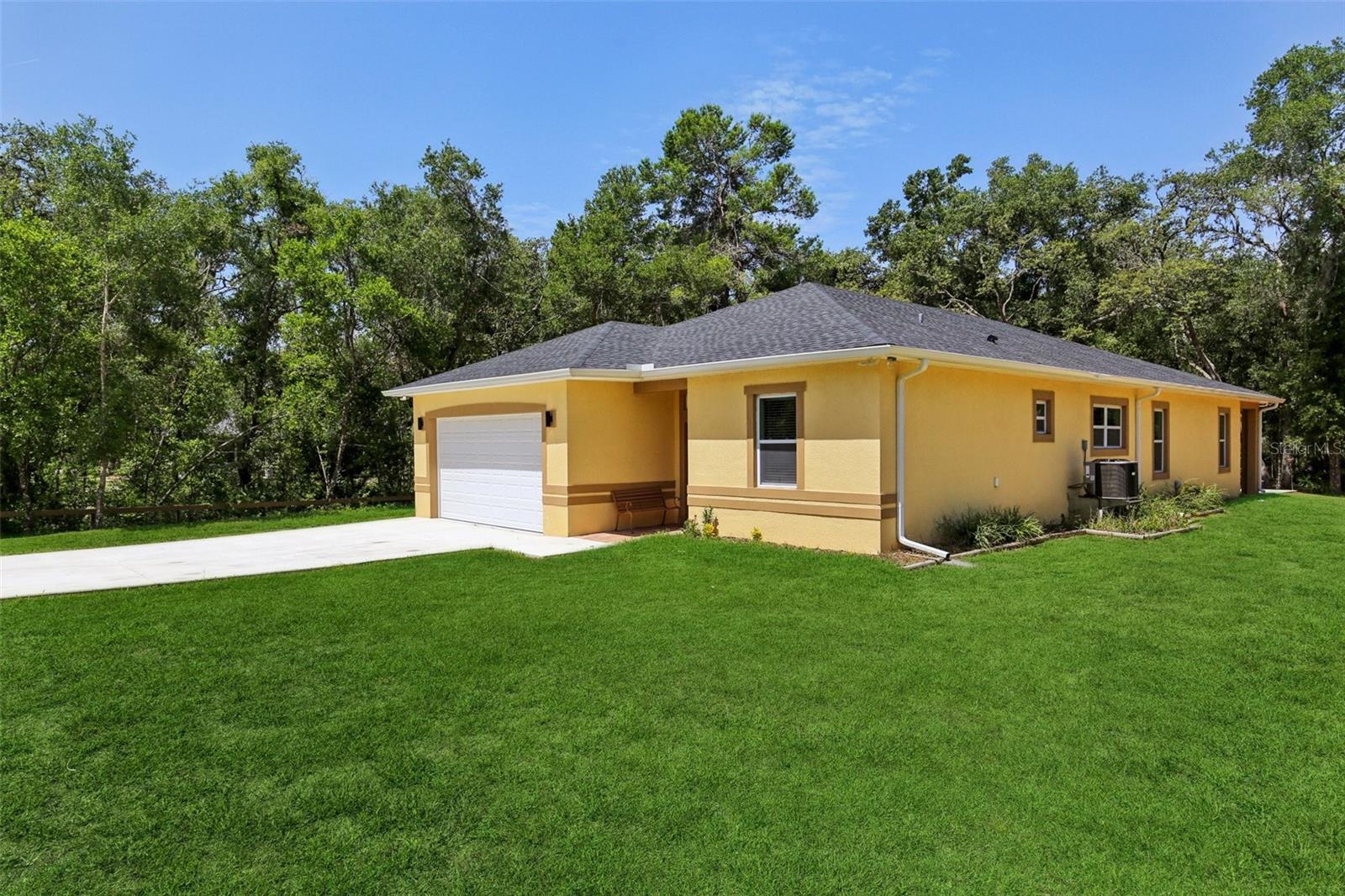 Modern Country Living Near City Conveniences!
Discover this stunning and meticulously maintained 4-bedroom, 3-bathroom home in Webster, FL, less than a year old and radiating modern charm. Boasting a spacious open-concept design, this residence features a gourmet kitchen with pristine white cabinetry, sparkling granite countertops, and a striking purple mosaic tile backsplash, perfectly complemented by stainless steel appliances and a large island with seating. The seamless flow into the living areas, adorned with sleek tile flooring throughout, creates an inviting space for relaxation and entertaining.
Enjoy the tranquility of a sprawling property, offering ample outdoor space for your enjoyment. The exterior showcases a charming yellow façade, a two-car garage, and a long driveway, all set against a backdrop of mature trees and lush greenery. A generous back patio provides the ideal spot for outdoor dining or simply unwinding amidst nature.
Conveniently located, this home offers the best of both worlds – peaceful country living with easy access to major Florida destinations. You're less than an 45 mins away from:
* The Villages: For shopping, dining, and entertainment.
* Orlando: Home to world-famous attractions and vibrant city life.
* Tampa: A bustling metropolitan hub with diverse opportunities.
Additionally, the stunning sands of Clearwater Beach are approximately 60 miles away, making for an easy day trip to one of Florida's most beloved coastal destinations.
This home is an exceptional opportunity to own a nearly new, modern residence in a desirable location. Don't miss out on making this dream home yours!