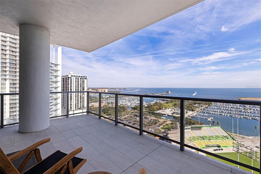 Welcome to Residence 2103 at Saltaire. Perched on the 21st floor in the tower’s most coveted corner with a northeast exposure, this residence offers sweeping, unobstructed views of Tampa Bay, the St. Pete Pier, and the downtown skyline. This rare 2,712 sq ft, three-bedroom, four-bath home combines refined design, modern convenience, and resort-style amenities in one of St. Pete’s most desirable luxury high-rises. It is the largest floor plan in the building other than the penthouse.

Floor-to-ceiling glass captures expansive water and city vistas from sunrise over the bay to the glow of downtown at sunset, while automated shades provide effortless comfort at the touch of a button. The open-concept layout is ideal for both everyday living and entertaining. The gourmet kitchen enjoys stunning views and features JennAir appliances, sleek stone countertops, and an oversized island with seating for four. The adjoining living and dining spaces flow seamlessly to a covered terrace, creating the perfect setting for morning coffee over the bay or evening cocktails as the city comes alive.

A thoughtfully designed split floor plan ensures privacy throughout. The primary suite offers inspiring panoramic views and an elevated bathroom retreat with dual vanities, a soaking tub, a separate walk-in shower, and two generous walk-in closets. The guest wing includes two additional bedrooms, each with en-suite baths and walk-in closets, along with a full guest bath and a spacious laundry room. A separate enclosed den with a transom window provides an ideal work-from-home space or media room.

This residence includes two secure garage parking spaces equipped with an EV charger, conveniently located just steps from the elevator.

Saltaire’s seventh-floor Aire Deck delivers a true resort-style experience, featuring a pool and spa with cabanas, outdoor kitchens with grills, and a bar with a large TV for movie nights or game days by the pool. On the same level, residents enjoy a bayfront fitness center, a private dog park, a clubroom, and multiple lounge spaces designed for relaxation and connection. Additional amenities include 24/7 lobby staff, concierge services, and valet parking.

Live in the heart of it all. Watch sailboats drift across the bay and small planes land at Albert Whitted Airport from your balcony. Walk to the Saturday Morning Market at Al Lang, catch a Rowdies game, enjoy dinner along Beach Drive, explore The Dali and other world-class museums, or unwind at the St. Pete Pier — all just steps from your front door.

This is more than a residence; it is the ultimate downtown St. Pete lifestyle, delivered at its finest.