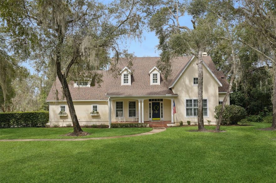Set on over an acre of naturally private land with no HOA and no rear neighbors, this 5-bedroom, 3.5-bath, 3,051 sq ft home in Mount Dora’s desirable Elysium Club neighborhood blends timeless craftsmanship with thoughtful modern updates. Built by highly regarded builder Keith Fields and renovated in 2013, the home welcomes you with a private dining area just off the entry and warm knotty pine wood flooring that flows throughout most of the home. The updated kitchen features unique brick flooring, a gas stove, and a charming butler’s pantry, with a half bath, spacious laundry room, and side-facing garage access conveniently located just beyond. The primary suite is located downstairs, while the remaining bedrooms and a bonus room are upstairs. The upstairs bathrooms have been beautifully redone, and there’s no carpet except in one bedroom, with elegant marble flooring in the baths. Nearly all windows feature shutters, enhancing the home’s character and charm. Out back, enjoy the peaceful conservation setting from the enclosed brick-floored porch or relax on the open patio seating area. Major upgrades including a new roof (2024), new HVAC (2023), and a wholehome water filtration system offer peace of mind. With its exceptional setting, quality construction, and thoughtful renovations, this Mount Dora residence offers a rare combination of privacy, character, and modern comfort.