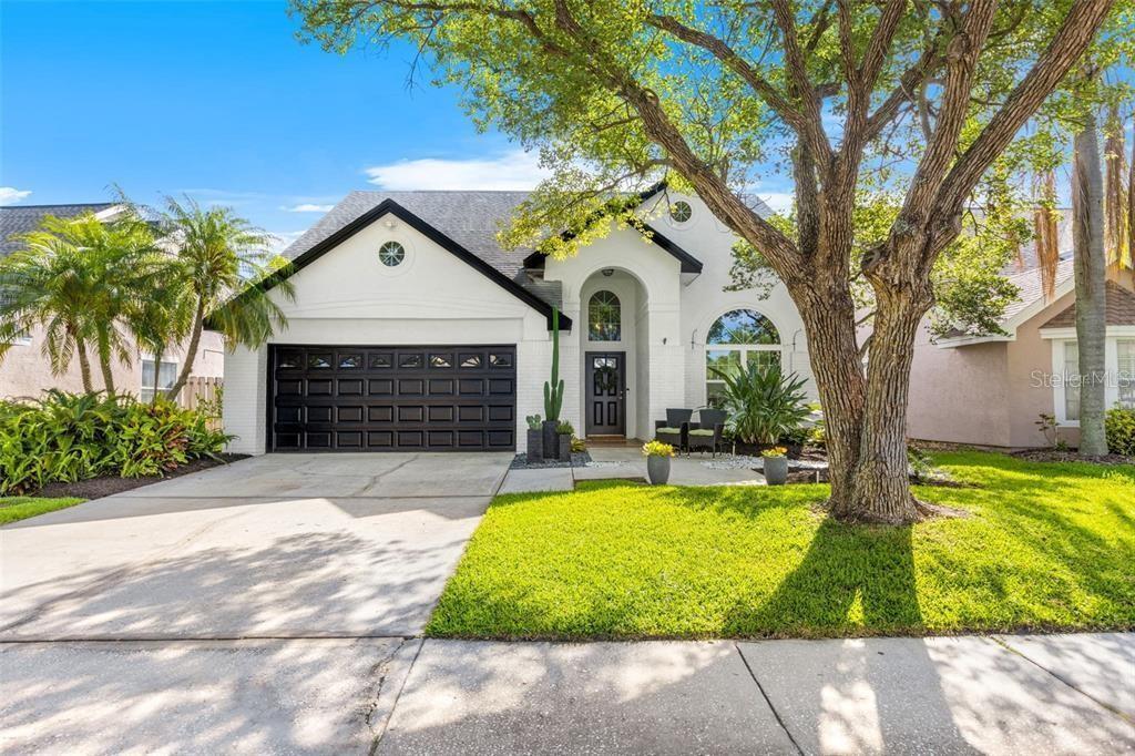 Fall in love with this elegant, 5 bedroom, 3 bath POOL & SPA residence, located on a tree-lined, cul-de-sac street in the popular neighborhood of Country Club Village at Carrollwood. This home offers the perfect blend of luxury, comfort, and community. Walk into this stunning grand entrance with a 14.5 foot high ceiling and gorgeous, updated flooring into this impeccably maintained home. Unique pillars and architectural features in the dining room with more than enough space for your family to enjoy! The kitchen has been fully renovated with stainless-steel high-end smart appliances, custom wine rack, and top tier granite countertops and backsplash. Spacious living room with plenty of natural light from the gorgeous, oversized hurricane rated windows. The large master bedroom on the first floor features a luxurious master bathroom with granite countertops, double sinks, a soaking tub, oversized stand up shower, smart toilet and a generous walk-in closet! The interior laundry room and the guest bed/bathroom are also on the first floor. Upstairs you will find 3 additional, sizable bedrooms and one full-size bathroom. Step out back through your new French doors and enjoy this incredible, screened in POOL! String lights were installed inside the patio to create an amazing atmosphere at night. Fenced in yard with plenty of space on the side for storage. Newer impact resistant windows, newer Rheem hybrid, high efficiency, hot water heater! The garage is equipped with AC unit and insulated garage door and can be used as a workshop. Washer and Dryer are included! This home is centrally located near the popular Carrollwood Country Club where you can get a membership to golf at the 27 hole courses and enjoy all of their amenities such as Olympic-size pool, tennis, clubhouse, and more! Enjoy the convenience of nearby shopping centers, the local farmers market, and a variety of restaurants. A new community park and dog park down the street that is open to the public. Schedule a showing today.