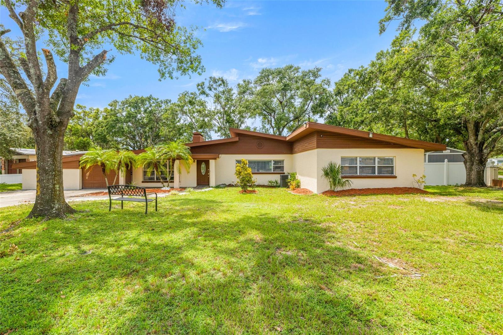 Two Houses for the Price of One! Welcome to this rare opportunity located directly on the scenic Babe Zaharias Golf Course. This property sits on nearly half an acre (0.40 acres) and offers not just one, but two complete living spaces—perfect for multi-generational living, house hacking, or rental income. The main home features 3 bedrooms, 2 bathrooms, a large great room, and a dedicated laundry room. The attached in-law suite—accessible through its own private entrance—includes 2 bedrooms, 2 bathrooms, a full kitchen, and a stackable washer and dryer, providing independence and privacy for extended family or tenants. Outside, the massive backyard provides plenty of space to create your dream outdoor retreat, with more than enough room to add a pool while still enjoying sweeping golf course views. Conveniently located just minutes from AdventHealth Tampa, Moffitt Cancer Center, James A. Haley Veterans’ Hospital, and the University of South Florida, this home combines peaceful surroundings with unbeatable accessibility. This is a one-of-a-kind chance to own a move-in ready home that combines comfort, flexibility, and unbeatable location.