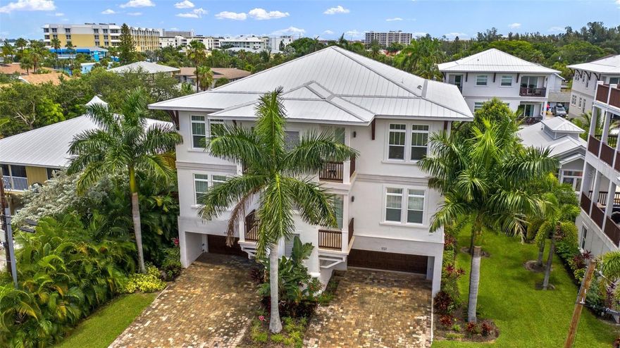 ***Potential for $150k+ gross income. Zoned for weekly rentals. ONE UNIT IN CONDO COMMUNITY*** Escape to the ultimate Siesta Key lifestyle with this rarely available, coastal contemporary condo—offering the perfect blend of luxury, privacy, and convenience with direct access to the sugar-white sands of world-renowned Siesta Key Beach and Crescent Beach. Known for its quartz-crystal sand and turquoise waters, this top-rated beach offers stunning sunsets, gentle waves, and vibrant coastal charm, all just a short stroll from your door. Nestled in a boutique enclave of only five residences, this exclusive unit has fresh interior paint, lives like a single-family home and is one of only two in its building. This unit encompasses the entire floor and shares no walls with other units. With five private patios, a built-in outdoor grill, tall ceilings and windows, and plantation shutters throughout, the light-filled layout offers an open flow between living, dining, and kitchen spaces—accented by custom cabinetry, upscale finishes throughout. The spacious primary suite provides a private retreat, while the entire home is thoughtfully designed on one level for effortless living. A private elevator offers direct access from your oversized ground-level garage, which is nearly 1,000 square feet and accommodates three vehicles plus storage, along with a private driveway for guest parking — a rare find on the Key. This property is zoned for short-term, weekly rentals and boasts a strong rental history, making it an exceptional opportunity for both personal enjoyment and possibility to earn over $150,000 in investment income. Enjoy walkable access to beachside boutiques, island restaurants, and boat rentals, plus quick and easy access on and off the island, making it ideal for both full-time living and a low-maintenance vacation home. Shared amenities include a serene pool, private owner's clubhouse, and common area used by only five residences, ensuring a peaceful and private setting. Whether you're searching for a serene retreat or a stylish beach escape with income potential, this home offers a unique opportunity to live in the heart of Siesta Key’s coastal paradise. Furnishings optional - not included in list price.