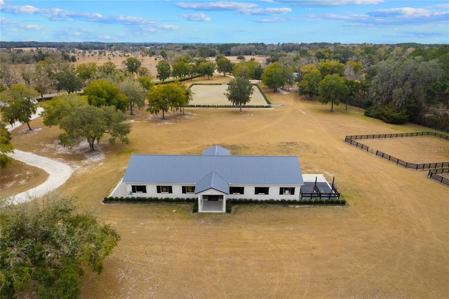 This is a rare opportunity to acquire a high-quality, well-appointed equestrian estate of 24+ acres near WEC, offering exceptional training facilities, solid infrastructure, and the option for a fully equipped, move-in-ready operation in the heart of Ocala’s premier horse country.
Discover an exceptional, turnkey equestrian property ideally located 15 minutes from the World Equestrian Center. and 7 from HITS. Designed with both performance and functionality in mind, this meticulously developed farm offers premium facilities, quality construction, and the rare opportunity to purchase fully equipped and furnished.
The impressive 36’ x 120’ center-aisle barn features eight (8) spacious 12’ x 14’ stalls, each equipped with 4’ x 4’ windows, providing excellent light and ventilation. The barn includes two concrete pads on each end, with the rear housing two wash stalls. A dedicated office/tack room complete with a bathroom, provides a comfortable and efficient space for barn management. Additional amenities include a separate laundry room and a feed room, ensuring organization, convenience, and smooth daily operations for a fully functional equestrian facility. Both the barn and wash rack are serviced with hot and cold water. All metal work, including stalls and doors, was custom completed by Double R, reflecting superior craftsmanship throughout.
At the heart of the training facilities is a Wordley-Martin riding arena measuring 150’ x 250’, fully irrigated and operating on a timed system, ensuring consistent footing year-round. The property is fully fenced by Seminole Fencing.
It features eight generously sized paddocks, thoughtfully laid out and enhanced with mature trees that provide natural shade, offering a comfortable and functional environment for horses year-round. Additionally, a large paddock of nearly 5 acres provides ample space for turnout and grazing and is equipped with two run-in sheds/stalls, delivering flexibility, shelter, and convenience for a variety of equestrian needs. Also there are two wells and septic tanks, and 2 RV hook ups.

The thoughtfully designed 36 x 72 barndominium (2,592 sq. ft.) blends functionality with modern elegance. 
The 1,728 sq. ft. apartment is a striking living space featuring soaring 20-foot ceilings and large, custom-designed windows that flood the interior with natural light while offering stunning views of the arena. The interior showcases a sleek, modern design, creating an open and airy ambiance throughout. Fully furnished and equipped, this turnkey residence provides both comfort and style, making it perfect as a primary home, guest quarters, or income-producing opportunity.
A spacious 864 sq. ft. garage offers ample room for multiple vehicles, equipment, and tools—ideal for both everyday use and farm operations.
Also conveying with the property:
2022 Kubota L2501 4-wheel-drive tractor, lightly used at approximately 150 hours per year, equipped with a front loader bucket and Brush Hog attachment.
2025 Tiger Cat 61” zero-turn mower, recently purchased in November 2025. Wordley Martin ring drag. 100 lb spiker seeder drop spreader for pasture and ground care.
8’ x 8’ heavy-duty harrow drag for paddock conditioning.
Various tools and equipment, including Stihl hedge trimmers, Stihl chainsaw, fuel cans, and other essential farm tools.
This is a must see! Make your appointment now!