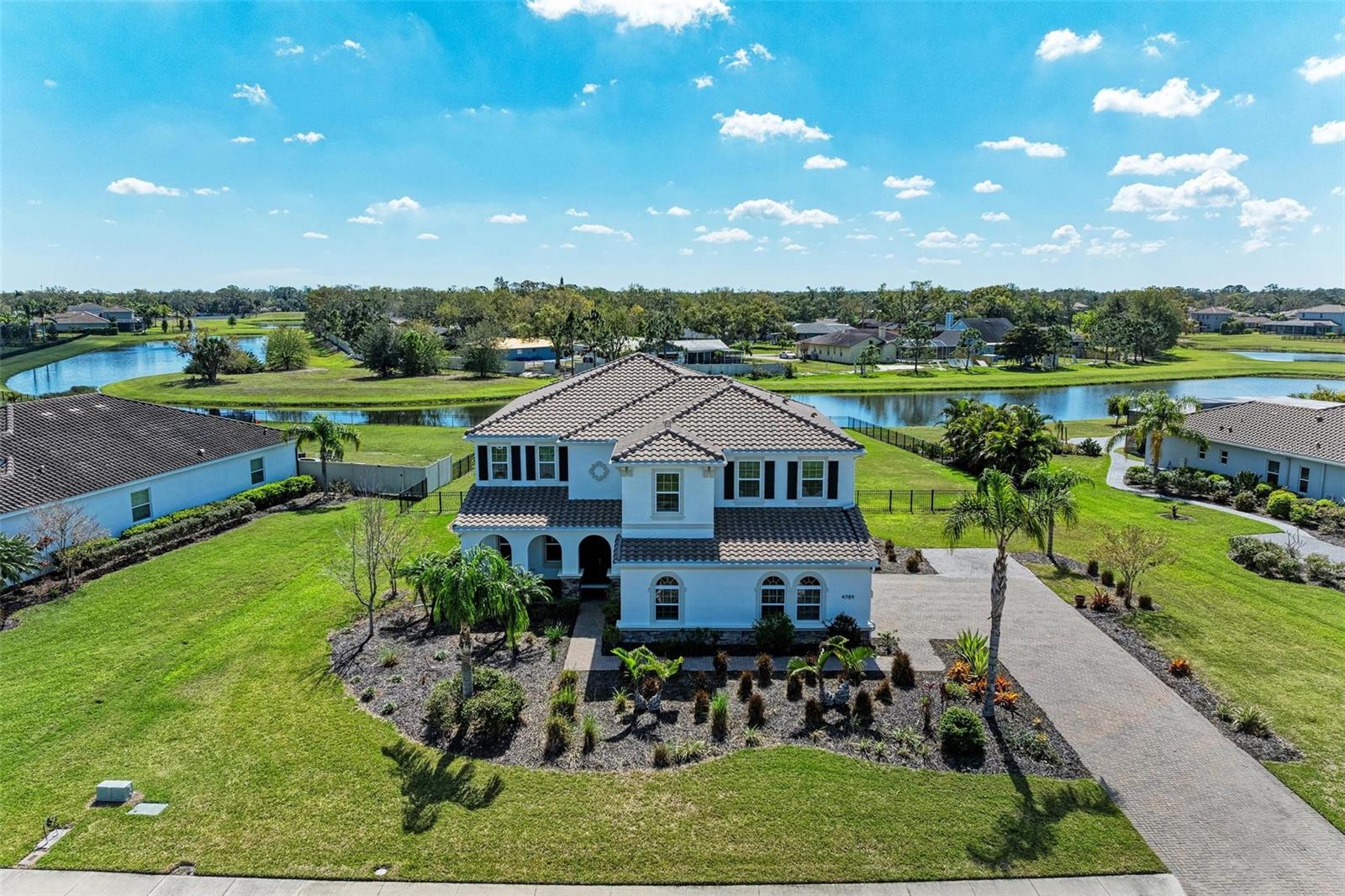 Luxurious Living in the Heart of Sarasota Welcome to your dream home nestled in the prestigious gated community of Vilano. This exquisite 5-bedroom, 4.5-bathroom residence boasts 4,420 spacious square feet of luxurious living , offering a perfect blend of elegance, comfort, and superior location. As you enter this magnificent two-story home, you are greeted by high ceilings and an expansive layout designed to provide an unparalleled living experience. The home is situated on a generous 1-acre lot, offering breathtaking views overlooking a serene pond. With such a huge back yard, there is an excellent opportunity to create the perfect Oasis with a custom swimming pool and spa, palm trees, sun tanning spaces and so much more. The barrel tile roof and side entry 3-car garage add to the grandeur, while the brick paver driveway and sidewalk enhance the home's curb appeal. The heart of this home is its enormous gourmet kitchen, designed to satisfy even the most discerning chef. It features stainless steel appliances, a smooth cooktop, and a large island perfect for meal preparation. The kitchen also includes a bar with seating and overhead pendant lighting, 42” stepped and staggered designer cabinets with crown molding, below cabinet lighting, a stylish backsplash, and a convenient desk area for organizing grocery lists. The breakfast nook is a cozy spot for casual dining, making it the perfect place to start your day. The primary bedroom is a true retreat, measuring 20 x 19 and featuring double entry doors. The primary bathroom is equally impressive, with separate oversized vanities, a sit-down area, and a large walk-in shower. Three of the four additional bedrooms are oversized en suites, providing ample space and privacy for family members or guests. The large bonus room offers endless possibilities for entertainment, gaming, or fitness activities, while the utility room is equipped with an upgraded washer, dryer, utility sink, and upper cabinets for additional storage. Outdoor living is a delight with a summer kitchen on the large lanai, perfect for hosting gatherings while enjoying the beautiful backyard and pond views. The home features 5 ¼” baseboards throughout, and several main living areas boast stair-stepped ceilings with 5 ¼” crown molding, adding an extra touch of sophistication. Location is everything, and this home is perfectly positioned to take advantage of all that the area has to offer. You are just a 15-minute drive to the University Town Center mall, a 20-25 minute drive to downtown Sarasota, and approximately 15 minutes to downtown Lakewood Ranch. Enjoy easy access to a variety of restaurants, entertainment options, shopping, medical facilities, and outdoor activities. The world-class beaches of Siesta Key are within a 30-35 minute drive, allowing you to indulge in the best of coastal living. This luxurious, spacious home in a highly desirable location is more than just a place to live—it's a lifestyle. Don't miss the opportunity to make this dream home your reality. Contact us today to schedule a private tour and experience the elegance and comfort of Vilano living.