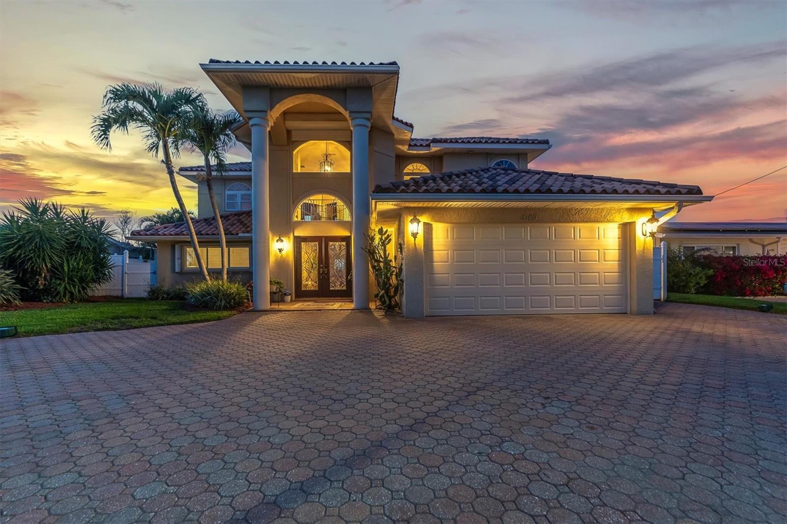 Welcome to Paradise where you can enjoy the luxury coastal living lifestyle! As you pull up you will notice the attention to detail starting with the paver circular driveway. High ceilings and grand entryway make this home stand out! This 4 bedroom, 3 bath pool home with a 19000 pound boat lift will speak to all your senses. The open floor plan accents the expansive views of the majestic waterways, approximately 70 feet of waterway and heated saltwater pool with spa, comes with a lift/elevator making it a breeze to go up stairs. The high-end custom Kitchen offers a Thermador 6 Burner gas range with a pot filler and double ovens, granite countertops and tile throughout the first floor. The home has two primary master bedrooms with en-suite baths, one on the first floor and the one on the second floor that will check every box on your list, starting with the size, 30x17, a 10x10 walk in closet, en-suite bath, two sets of slider to the balcony to sit and enjoy our famous Florida sunsets. Every room has been thoughtfully designed to provide a harmonious blend of luxury and functionality. Step outside to the expansive waterfront deck, where you can indulge in outdoor living at its finest. The home is fitted with hurricane shutters for all windows and impact rated front entry doors. The raised newer seawall ensures privacy and security, while the deepwater canal offers direct access to the open waters, making it perfect for boating enthusiasts. Imagine entertaining guests on your private patio while enjoying the serene water views or launching your boat for a sunset cruise without the hassle of fixed bridges. This Treasure Island gem is not just a home; it's a lifestyle. With the beach as well as numerous restaurants just a short walk away and the convenience of waterfront living, you'll relish the tranquility and beauty of your surroundings. Don't miss the opportunity to own this impeccable home in one of the most sought-after locations. The boat lift was installed 2005, A/C is dual control, Tankless gas water heater, reclaimed water for your irrigation needs, newer sea wall, brand new dock power box installed and the newer lift/elevator being serviced the end of the month. Furnishings are optional. This home is near where they are doing the Tv Show Rock the Block.