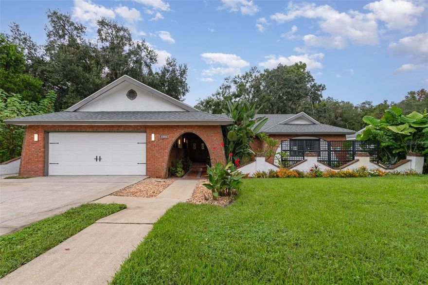 UNIQUE WATER-FRONT-CANAL HOME & HOA FREE!  An exceptional custom-designed property reflecting the Spanish Mediterranean architecture with a large OPEN FLOOR PLAN!  This home boasts 4 bedrooms and 3 bathrooms, including a private suite reminiscent of a mother-in-law's quarters. It highlights custom-designed arches, complemented by brick and masonry details, as well as a nice wood-burning fireplace.  The kitchen is crafted for both functionality and aesthetics, featuring 1" granite countertops, a large kitchen island, and equipped with stainless steel appliances, a flat cooktop with an oven, as well as ample counter and cabinet space.  Numerous updates!  A NEW KITCHEN WITH DOUBLE OVEN, NEW FLOORING THROUGHOUT THE RESIDENCE FEATURING ELEGANT SPANIARD TILE IN THE KITCHEN, RENOVATED BATHROOMS, FRESH PAINT, NEW PATIO DOORS, UPDATED LIGHT FIXTURES, AND A NEW BOAT DECK. THE ROOF IS JUST -2YEARS OLD, WHILE THE WELL PUMP AND HVAC SYSTEM ARE ONLY 5- AND 7-YEARS OLD, RESPECTIVELY. ADDITIONALLY, THERE IS A NEW IRRIGATION PUMP ALONG WITH A NEW FILTRATION AND SOFT WATER SYSTEM.  For those who are passionate about hobbies or automobiles, you will appreciate the two-car garage, which offers plenty of driveway parking space capable of accommodating 4-extra vehicles.  This exceptional property is located in a large lot that provides access to Lake Harris, and it includes two covered docks as well as a boat lift.  You will even appreciate the opportunity to access numerous restaurants via a short boat ride.  Yes, pet friendly!  You are invited to bring your pets to experience the peacefulness of rural life and water sports access.  AFFORDABILITY IS KEY, AS THE CURRENT UTILITIES ARE APPROXIMATE $250 PER MONTH.  You are minutes to the Turnpike, giving you easy access to Orlando, the beaches, theme parks, and the airport.  Convenient access to shopping, dining, medical facilities, and great schools makes this property rare to find.  Ultimately, enjoy the perfect blend of water front and access, country living, privacy, and convenience—welcome home to Leesburg!