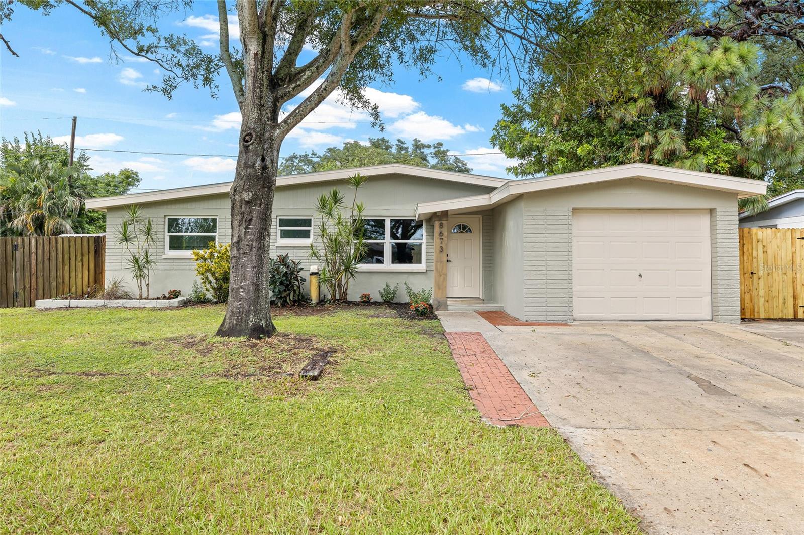 Welcome to this beautifully renovated 3-bedroom, 1-bathroom home in the heart of Seminole, offering style, functionality, and peace of mind. With adorable curb appeal and a welcoming front entry, this home invites you in from the moment you arrive. Inside, you’re greeted by soaring vaulted ceilings and a bright, open-concept layout. The spacious living room features a trendy accent wall and flows seamlessly into the dining area and modern kitchen, which boasts brand-new cabinetry, stainless steel appliances, and sleek countertops—perfect for both everyday living and entertaining. Each of the three bedrooms offers high ceilings, ample natural light, and a cozy yet airy feel. The updated bathroom is both stylish and functional, featuring contemporary finishes. Just off the kitchen, you’ll find a convenient laundry room that leads directly into the attached one-car garage. Step outside to enjoy the spacious screened-in back porch overlooking a fully fenced backyard—ideal for relaxing, hosting guests, or letting pets play safely. Additional upgrades include new windows, a new roof, and a 2018 HVAC system, providing comfort and energy efficiency year-round. Best of all, this property is located in an X500 flood zone, which means no flood insurance is required, and it did not flood during last year’s hurricanes—offering valuable peace of mind. Centrally located just 15 minutes from Madeira Beach, 25 minutes from downtown St. Petersburg, and close to top-rated schools, shops, and restaurants, this home is the perfect blend of comfort, convenience, and coastal living. Don’t miss this move-in-ready gem—schedule your showing today!