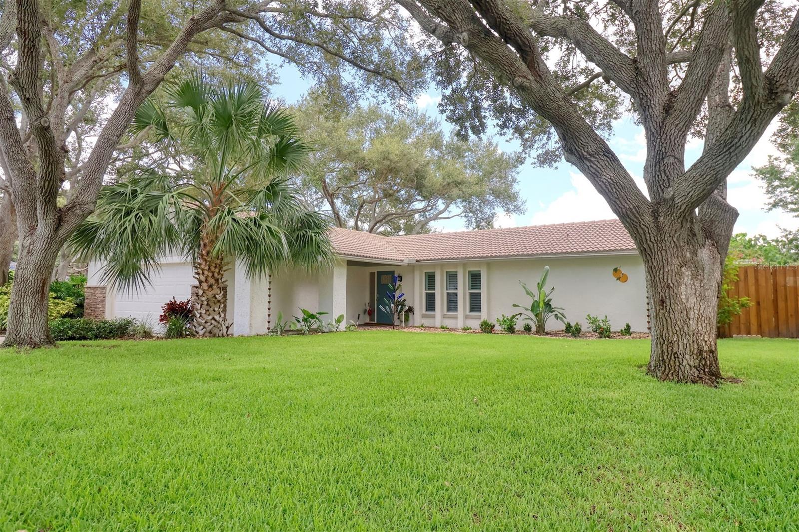 Under contract-accepting backup offers. More Pics to follow. This tres chic 3 bedroom, 2 bath pool home sits gracefully on an oversized 1/4 acre fenced corner lot, NOT A FLOOD ZONE in the desirable Ranchwood Estates neighborhood in delightful Dunedin golf cart area. Jump into your golf cart and venture downtown for dinner, or one of the many festivals or farmers markets. This beautifully renovated home boasts a large family room, formal dining room and living room, 3 generous sized bedrooms, 2 full bathrooms, a Florida room and a spacious kitchen with exquisite quartz countertops, 42" cabinets and newer stainless steel appliances including a brand new induction range. The primary bedroom is split from the other 2 bedrooms and is a bright and spacious retreat with newer impact sliders that open to the oversize swimming pool. The primary bathroom is also spacious with dual sinks, and a generous shower stall. The huge backyard offers privacy, a large patio for a seamless blend of indoor/outdoor entertainment living, and is fenced for privacy and pool safety. This home is move in ready with tasteful touches such as; neutral color tones, newer fans, modern light fixtures, and wood look tile floors throughout this impeccably clean and welcoming home. This home also features impact windows, newer flat roof (2018), Tile roof (2012), and a newer hurricane garage door. There is plenty of natural light and room to grow in this well laid out open floor plan. Couple this with excellent schools and close to shops, airports, beaches and all that fabulous downtown Dunedin has to offer and you have the perfect Florida lifestyle home.