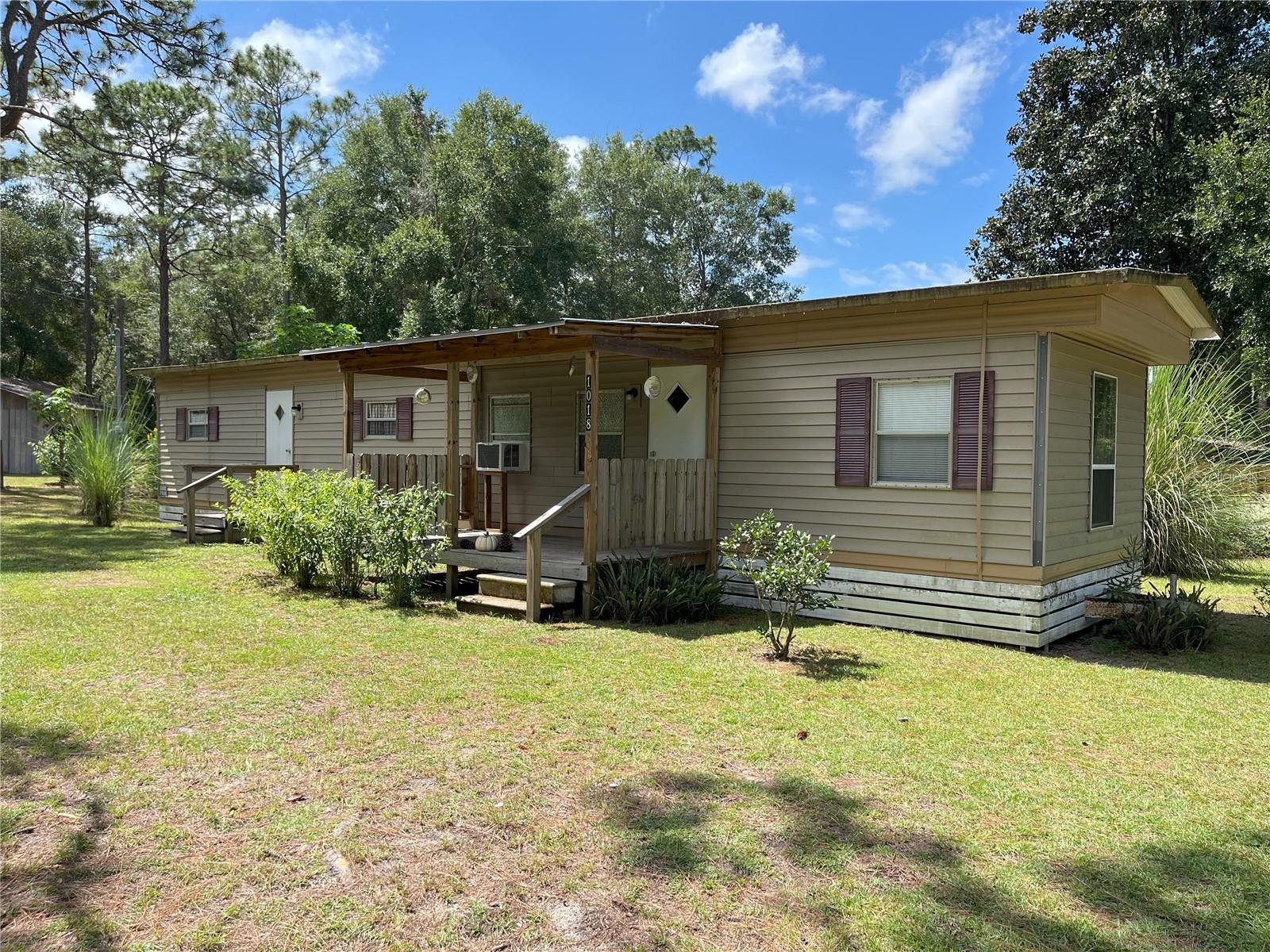 Charming 2-Bed, 1-Bath Mobile Home on a Double Landscaped Lot – Country Setting Near Ocala National Forest!
Welcome home to you country getaway perfectly situated on a spacious double lot with endless possibilities! Whether you dream of gardens, additional buildings, or even a pool, this property offers plenty of room to make it your own.
Step outside and enjoy the serene country setting, bordered by the Ocala National Forest yet less than a half mile from everyday conveniences like shopping, dining, medical services, and more.
Recent upgrades give you peace of mind, including:
New Well Pump (2025)
200 Amp Exterior Power Service & Pole (2023)
New Interior Panel, Breakers & Wiring (2022)
New Plumbing & Full Bathroom (2022)
Spray Foam Insulation & Drywall (2022)
Additional features include front and rear covered porches, a 12x12 shed with electric, greenhouse, raised garden beds, and fully fenced with a gated entrance for privacy. Simply bring your finishing touches!
Outdoor enthusiasts will love being less than 7 miles from Ray Wayside Park, boat ramps, Silver River, Moss Bluff Dam, public shooting ranges, hiking trails, and in he area there are over 20 lakes with recreation and camping opportunities.
Seller financing available!
This is your chance to own a unique property in a one-of-a-kind location—perfect as a primary home, weekend retreat, or investment opportunity.
Call today to schedule your private tour!