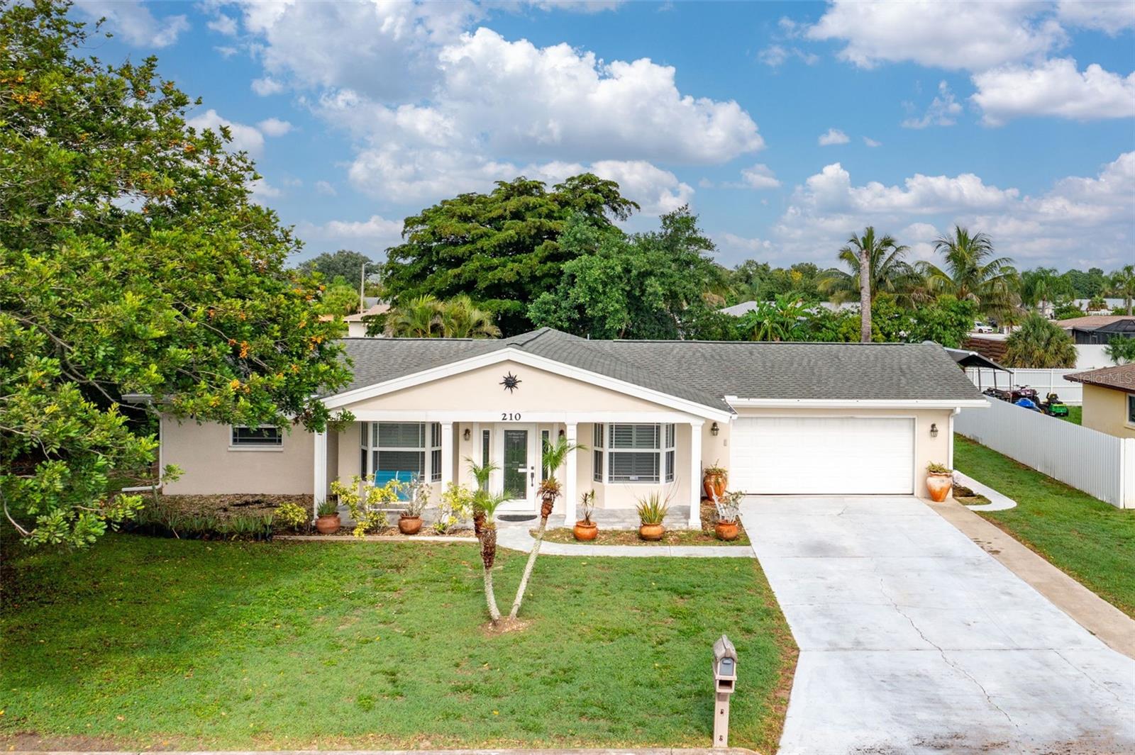 Spacious 3-bedroom, 2-bath single-family home offering 1,653 sq ft of comfortable living space on a 0.24-acre lot. Features include an updated kitchen with granite countertops and breakfast bar, tile and laminate flooring, hurricane impact windows, a large enclosed lanai, mature trees, tropical landscaping, and an attached two-car garage. Solid block construction built in 1973. Additional highlights include underground utilities (no overhead power lines), central water and sewer, a fire hydrant across the street, and a versatile bonus room perfect for an exercise room, home office, family room, or game room. Located within 3 blocks of the new Lehigh Elementary School in a quiet neighborhood with no HOA, close proximity to shopping, dining, and commuter routes. Home is also in a unincorporated location, allowing potential to Airbnb.