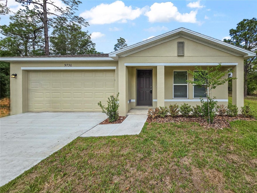 This beautiful new construction home features 4 bedrooms and 2 bathrooms across a spacious and thoughtfully designed 1,672 square feet of living space. Located at 9730 N Elkcam Blvd in the serene community of Citrus Springs, FL, this residence offers a perfect blend of modern style and functional comfort. As you step inside, you are greeted by an expansive open-concept great room that flows seamlessly into the dining area and a contemporary kitchen, ideal for daily living and easy movement. The kitchen boasting sleek white cabinetry, granite countertops, stainless steel appliances, and a convenient breakfast bar for casual morning meals. The interior is finished with stylish, durable wood-look flooring and a neutral color palette that complements the abundance of natural light streaming through the large windows. Retreat to the private owners suite, which includes a generous walk-in closet and an en-suite bath featuring dual vanities. Outside, the property includes a two-car garage and a covered patio area perfect for enjoying the peaceful Florida weather. Situated in Citrus County, this home provides a wonderful opportunity to enjoy a brand-new space in a growing and vibrant neighborhood. Disclosure: Some images have been virtually staged to better showcase the true potential of rooms and spaces in the home