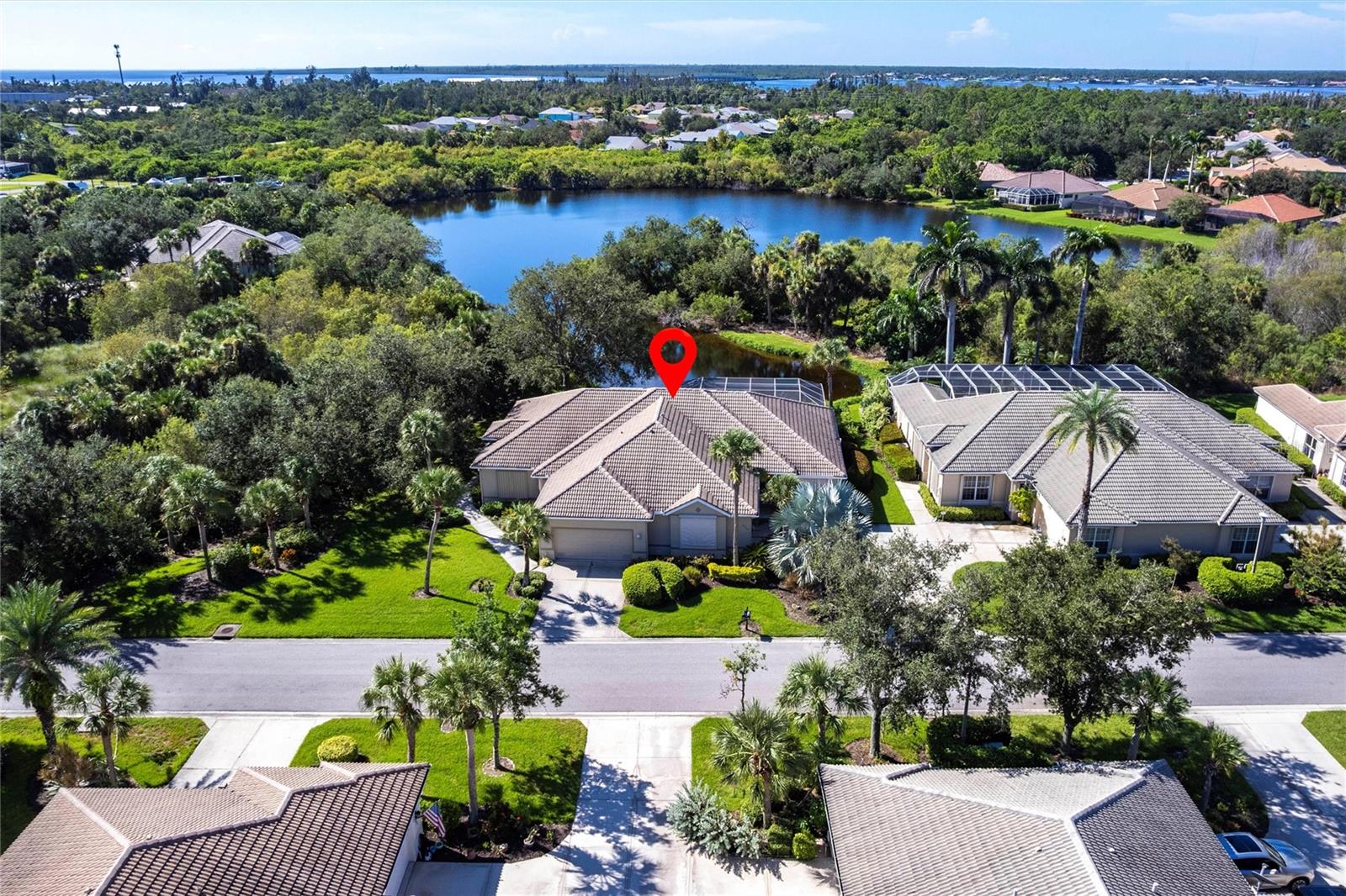 TURNKEY FURNISHED Lakefront Home with Private Pool! Welcome to this beautifully maintained home in the highly sought-after, deed-restricted golf community of Riverwood, complete with a transferable Beach Club membership on Manasota Beach. Ideally situated on a peaceful cul-de-sac, this right-side 1,576 sq. ft. villa offers serene lake views and features 3 bedrooms, 2 bathrooms, a 2-car garage, and a screened-in private pool and lanai—creating the perfect outdoor oasis for entertaining or relaxing in complete privacy. Lush tropical landscaping enhances the home’s curb appeal, while the low-maintenance design makes it ideal for year-round living or seasonal retreats. The open, split floor plan welcomes you with warm laminate flooring throughout the main living areas. High ceilings and sliding glass doors in the living room open to the lanai and pool area, while the dining area features French doors leading directly outside—providing seamless indoor-outdoor flow. The kitchen, the heart of the home, offers solid surface countertops, crisp white cabinetry, coordinating tile backsplash, full appliance package, and abundant storage. The open layout connects it to the living areas, with wood-look flooring and a tropical-inspired ceiling fan adding charm and character. The spacious Primary Suite boasts a generous walk-in closet and en-suite bath with a Roman shower. Two additional bedrooms with ample closet space share a full bathroom—one includes a Murphy bed and desk area, ideal for a home office or flex space. Step outside to your private screened lanai and sparkling pool with spa, overlooking a tranquil waterway. The outdoor area offers ample space for lounging or dining al fresco, surrounded by lush landscaping and peaceful views—the ultimate spot to soak up the Florida lifestyle. Additional features include a laundry room with stackable washer/dryer and utility sink, large two-car garage, generator, hurricane shutters, tile roof, and solar-heated pool. Riverwood is a gated golf community featuring a par-72 championship public course, updated sports campus with state-of-the-art fitness center, zero-entry resort pool, tiki bar, tennis and pickleball courts, and a wide range of fitness and social activities including bocce, croquet, and more. Enjoy scenic walks or bike rides through this pristine community. Separate fees apply for golf club and Manasota Key Beach Club memberships.
**PLEASE ENJOY THE 3D INTERACTIVE VIRTUAL TOUR ASSOCIATED WITH THIS LISTING**