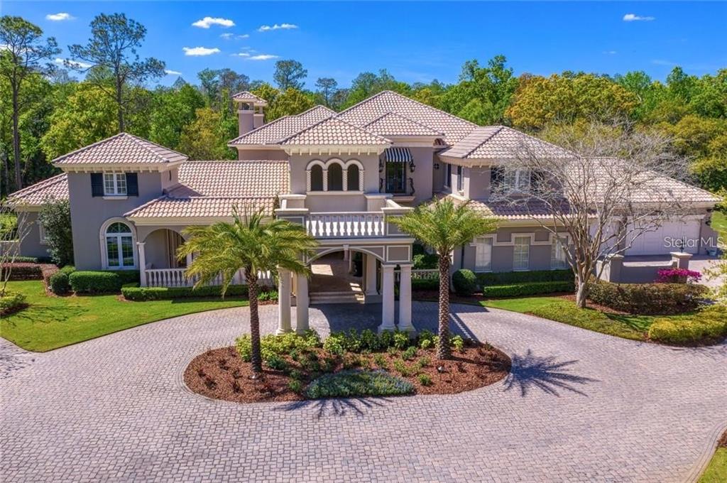 A Fechtel Company custom-built masterpiece with over 10,000 square feet of living space nestled on 14 acres in gated Turnbury Wood in the popular Tampa Palms community. Turnbury Wood is an exclusive village in Tampa Palms of only four homes--all on multi-acre homesites. In addition to the formal living room, dining room, kitchen, family room and casual dining, this home also features six bedrooms all with ensuite bathrooms, two half bathrooms, an office, billiards/game room, children's playroom, home theater, a loft, a home gym, wine cellar, crafts room and garages large enough to park seven cars. Spectacular pool and spa overlook stocked fishing pond and your very own wooded sanctuary. The extensive trim molding, travertine and wood flooring, stone columns, and many more fine details showcase this exquisite property. The gourmet kitchen features professional-grade appliances including a Thermador gas cooktop and ovens and a SubZero refrigerator. The wine cellar holds up to 800 bottles of wine. Guest accommodations include two semi-detached suites. One with a loft above and the other adjacent to the home gym and overlook the gleaming pool and spa. this home also features two gas fireplaces, a summer kitchen on the lanai, complete with a new Alfresco grill and a Big Green Egg, a safe room, a technology/security room, storage galore, a drop zone for the kids, an 18x12 laundry room with loads of storage and a mop/utility sink, a new sport court, a putting green with sand trap to work on your short game, gazebo, a stocked fishing pond with fountain, whole home technology and music system and so much more. Tampa Palms is conveniently located near one of the top elementary schools in Hillsborough County, Chiles Elementary. Also, close by you will find plenty of shopping, dining and recreation. The Tampa Palms Country Club is one of the finest in the Tampa Bay area and served as one of the stops on the Champions Tour (known as the Senior Tour at the time). A short drive to the University of South Florida, the James A. Haley VA Hospital, the Moffitt Cancer Center, Busch Gardens, Tampa Premium Outlet Mall, Wiregrass Mall, Shoppes at Wiregrass and a short commute to downtown Tampa.