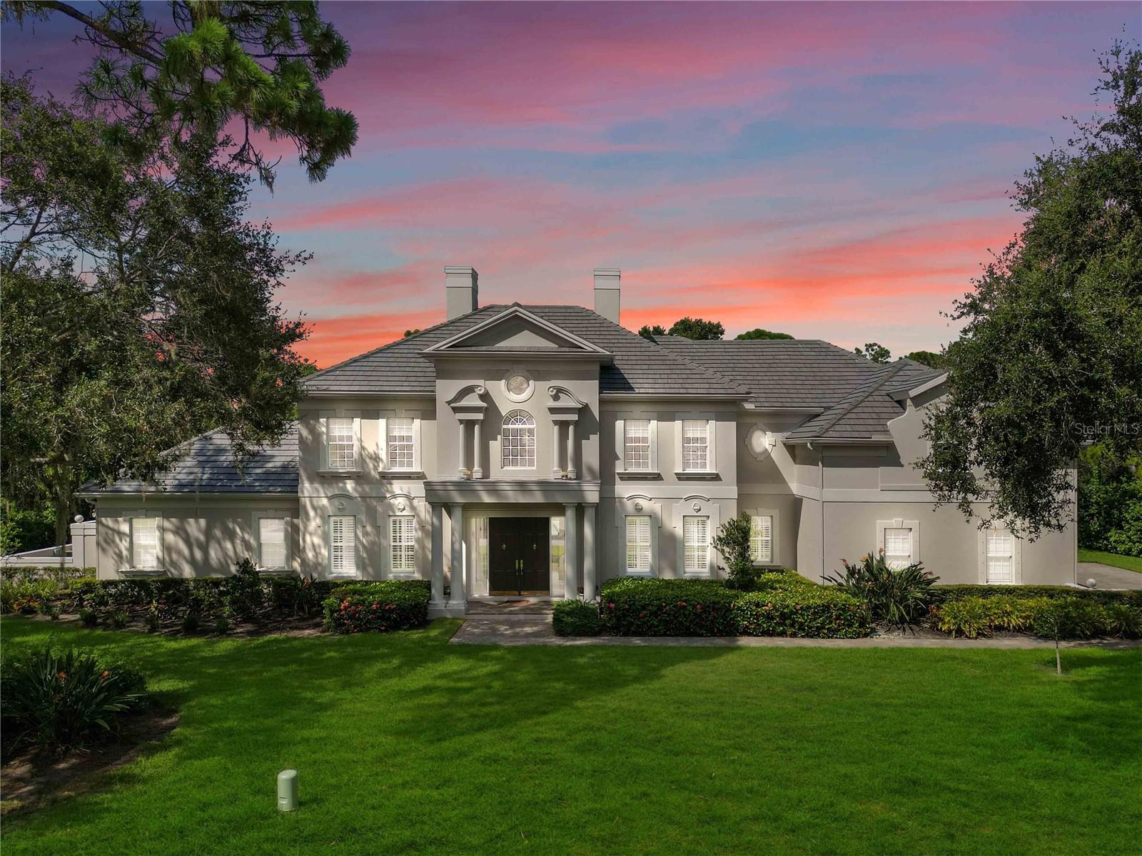 Introducing The Grand Estate at The Oaks Bayside! Roof is brand New 1 year old. Step into a world of opulence and tranquility, nestled within the exclusive gates of The Oaks Bayside. This remarkable residence stands as a testament to luxury living, enveloped by lush greenery, majestic oak trees, and vibrant tropical flora that set the stage for an extraordinary retreat. As you approach, a captivating driveway adorned with elegant pavers leads to the 3-car side-load garage, ensuring ample space for your vehicles. Welcoming you to the front porch are stately columns that frame the grand double-door entry, hinting at the lavish interior that lies beyond. Upon crossing the threshold, be prepared to be awed by the lavish details that define this residence. Marvel at the pristine marble flooring that gleams under the abundant natural light that bathes the space. The exquisite plantation shutters grace every window, inviting you to discover the myriad of exceptional features. To the left, an exquisite office awaits, replete with built-in bookshelves and a desk, ideal for productivity and focus. Pocketing doors provide an oasis of quiet when needed. To the right, an expansive open space with a backlit tray ceiling presents endless possibilities—a perfect enclave for your grand piano, a library of cherished books, or an elegant formal dining room. Ahead lies the formal living room, where a window of grand proportions transforms the outdoors into an integral part of your living experience. Towering ceilings, a crackling fireplace, and seamless access to the private pool area create an ambiance of comfort and sophistication. Prepare to be enamored by the kitchen's design, where a charming breakfast nook overlooks the pool through an aquarium window. A sprawling breakfast bar, dual sinks, an island for culinary creativity, a double wall oven, and a butler's pantry define the culinary haven. This space seamlessly transitions into the family room, where sliding glass doors open to the pool, accompanied by a wood-burning fireplace, a wet bar, and a convenient built-in desk—a haven for family togetherness. The master suite beckons with its spaciousness, complete with a cozy sitting area bathed in sunlight and pool access through sliding glass doors. The en suite bath boasts a walk-in shower and a garden tub with picturesque windows framing your private tropical haven. Outside, discover the ultimate private oasis—your pool area. A resplendent pool and separate spa take center stage, embraced by a travertine deck and a covered patio, making every day feel like a vacation. With 6000 square feet of living space, 5 bedrooms, 5 full bathrooms, and 2 half baths, this estate is a realm of comfort and luxury. 2 AC systems are 2 years old, And that's just the beginning! As a resident of The Oaks, you gain access to The Oaks Club, offering two golf courses, tennis courts, pickleball courts, a croquet court, a well-equipped fitness center, and exceptional dining. Conveniently situated near esteemed institutions like Pine View School, Historic Spanish Point, Casey Key, and Oscar Sherer State Park, you'll enjoy the best of both worlds—tranquility and accessibility. Your dream home is waiting. Schedule your private showing today and embrace a life of timeless elegance!