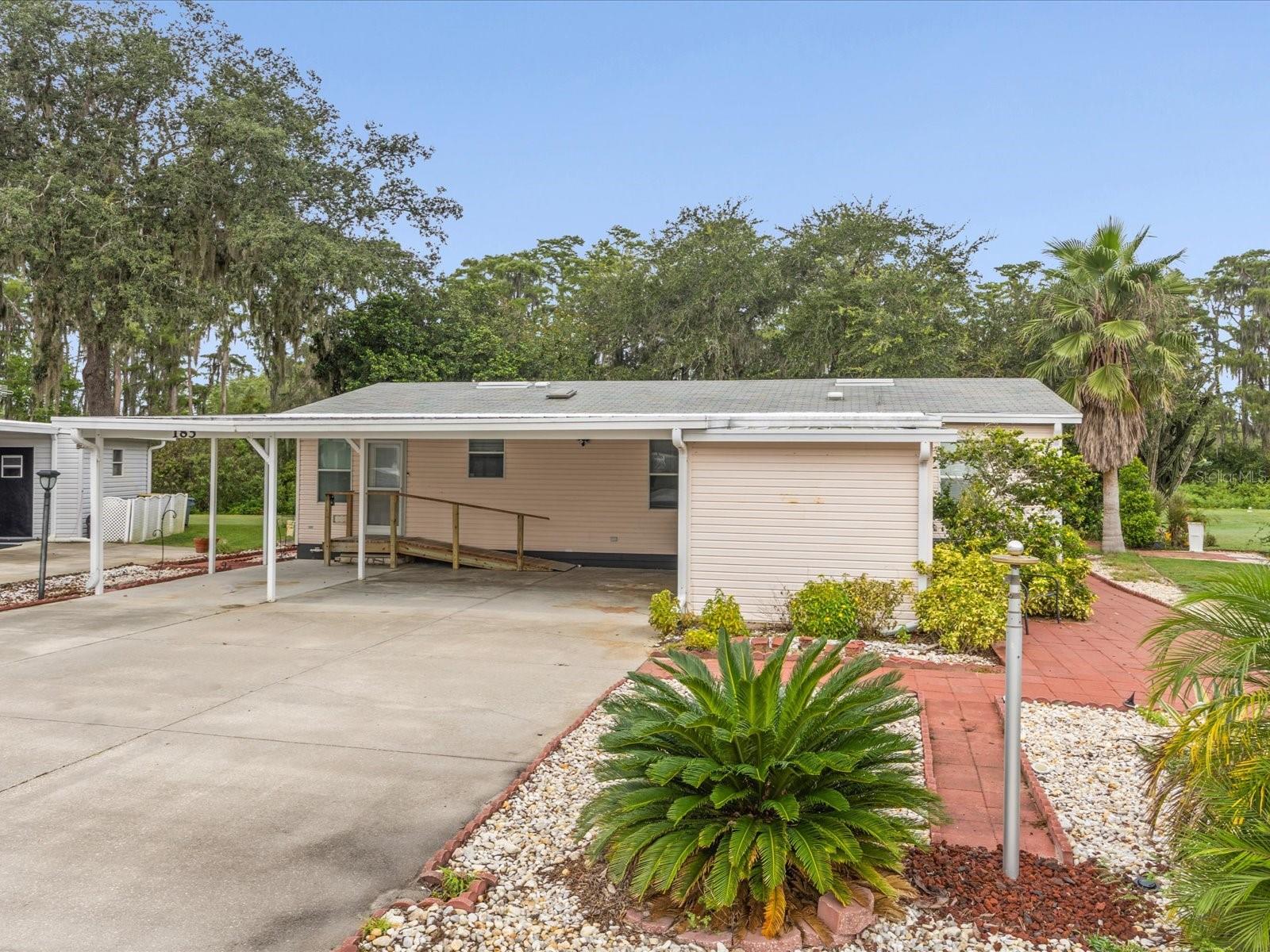 WOW- Florida Living within 15 minutes of Disney and OWN YOUR OWN LAND. Low HOA & Low Taxes.
This home sits on 4th hole of Polo Park West subdivision just off Hwy 27. All appliances replaced within last 5 to 7 years. New screens on the back lenai. Front & glass door are newer. AC & Hot Water Heater are less than 5 yrs old. Newer underpinning as well. No flood insurance required.
Large carport on the front for parking and/or sitting.