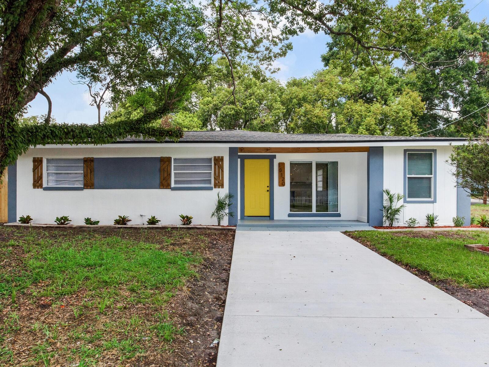 Welcome to your dream home on nearly a quarter acre in the heart of Tampa! Completely remodeled from the ground up, this property is essentially brand new while still offering a nod to mid-century modern design. From the moment you arrive, the curb appeal shines with matching mailbox, shutters, address sign, and front door beam. Inside, style is evident in every detail—the exposed beams contrast beautifully with fresh paint and highlight the soaring ceilings, while a painted fireplace warms the sleek and modern living space. Large windows fill the open layout with natural light, eliminating the need for daytime lighting. The designer kitchen is a showstopper with a quartz island perfect for gatherings, a deep gold farmhouse sink, above-cabinet lighting, and soft-close drawers. Off the main living area, a flexible bonus room with built-in shelving offers endless possibilities for a den, office, or formal dining room. The luxurious primary suite features a gold-accented ensuite with exquisite tile work, a spacious walk-in shower, and a barn-door entrance to a large closet. Three additional bedrooms are generously sized, complemented by a guest bathroom with the same level of detail and quality as the primary bath. Step outside to enjoy an oversized fenced backyard complete with a storage shed, large covered patio, and additional pavers for easy indoor-outdoor living. For peace of mind, every major element is new: roof, HVAC and ductwork, electrical, plumbing, interior and exterior paint, flooring, fixtures, appliances, and even some windows and fencing. Conveniently located near USF, Busch Gardens, Lowry Park Zoo, downtown Tampa, and with easy access to freeways and the airport, this home truly has it all—style, functionality, and an unbeatable location. The perfect opportunity for a lucky family or savvy investor to enjoy for years to come.