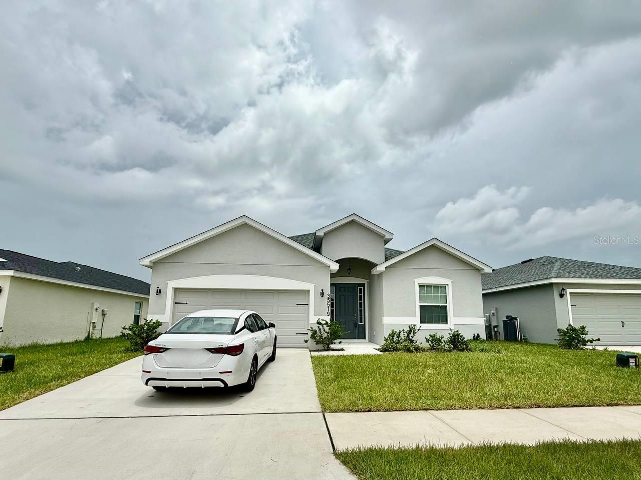 Welcome to this beautifully maintained 4-bedroom, 2.5-bathroom home with a spacious 2-car garage, located in the sought-after Stonebridge at Chapel Creek community in Zephyrhills. Designed for comfort and style, this home offers an ideal blend of elegance, functionality, and space. The heart of the home is the chefs dream kitchen, featuring stainless steel appliances, stone countertops, a large center island, abundant cabinetry, and an impressive walk-in pantry perfect for cooking, hosting, and everyday living. Throughout the home, you'll find wood-look laminate flooring and plush carpeting, creating a warm and inviting atmosphere. The primary suite is a true retreat, highlighted by tray ceilings, a spacious walk-in closet, and a luxurious en-suite bathroom with dual sinks and a large walk-in shower. Step outside through the glass sliders to a covered patio, ideal for relaxing or entertaining, overlooking a fully fenced backyard with a pond view, offering privacy and room to play. Located in the desirable Chapel Creek community, you'll enjoy access to upcoming resort-style amenities such as a pool and playground and be just minutes from shopping, dining, top-rated schools, and major roadways. In addition to the advertised base rent, all residents are enrolled in the Resident Benefits Package (RBP) for $50.00/month which includes HVAC air filter delivery, credit building to help boost your credit score with timely rent payments, utility concierge service making utility connection a breeze during your move-in, and much more! More details upon application. Pets welcome, no aggressive breeds. Vacant and available now!