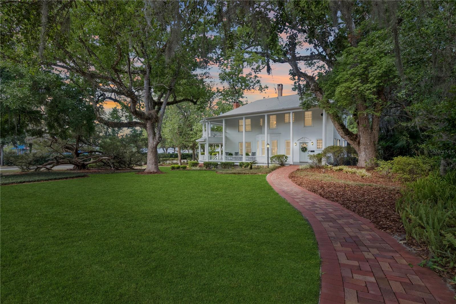 Timeless Historic Home with Wrap-Around Porch & Pool in the Heart of DeLand
Discover this move-in ready historic gem nestled in the highly sought-after historic district of DeLand, just a short stroll from Stetson University, the Athens Theatre, Northwest Square, and the vibrant shops and restaurants of Downtown DeLand. This spacious 4-bedroom, 2-bathroom home sits proudly on a corner lot property, offering a rare blend of original architectural details and modern upgrades. Step onto the stunning wrap-around porch or relax on the second-story balcony—perfect for enjoying the charm of this walkable neighborhood in DeLand. The beautifully landscaped grounds feature winding brick pathways, manicured gardens, and a private backyard oasis complete with a heated, screened-in saltwater pool, deck, and outdoor shower—an entertainer’s dream home. Inside, you’ll find original cypress floors, intricate moldings, and abundant natural light throughout. The updated kitchen is a showstopper, boasting brand-new cabinets, quartz countertops, tile backsplash, stainless steel appliances, laminate flooring, and French doors that open directly to the pool deck.
The first floor includes a formal living room with fireplace, a spacious dining room, a full bathroom, a cozy breakfast nook, an adjacent sitting room, a large family room with fireplace, a laundry closet, and a guest bedroom. Upstairs, the primary suite features a private balcony, accompanied by two additional bedrooms and a full bath. Additional upgrades include new ceiling fans and light fixtures, replaced decking on the back and side porches, and modern outdoor LED lighting that highlights the home’s timeless elegance and curb appeal. Roof replaced in 2021. Whether you're sipping coffee on the porch, enjoying a swim, or exploring the best of DeLand, this home offers unmatched lifestyle and charm.