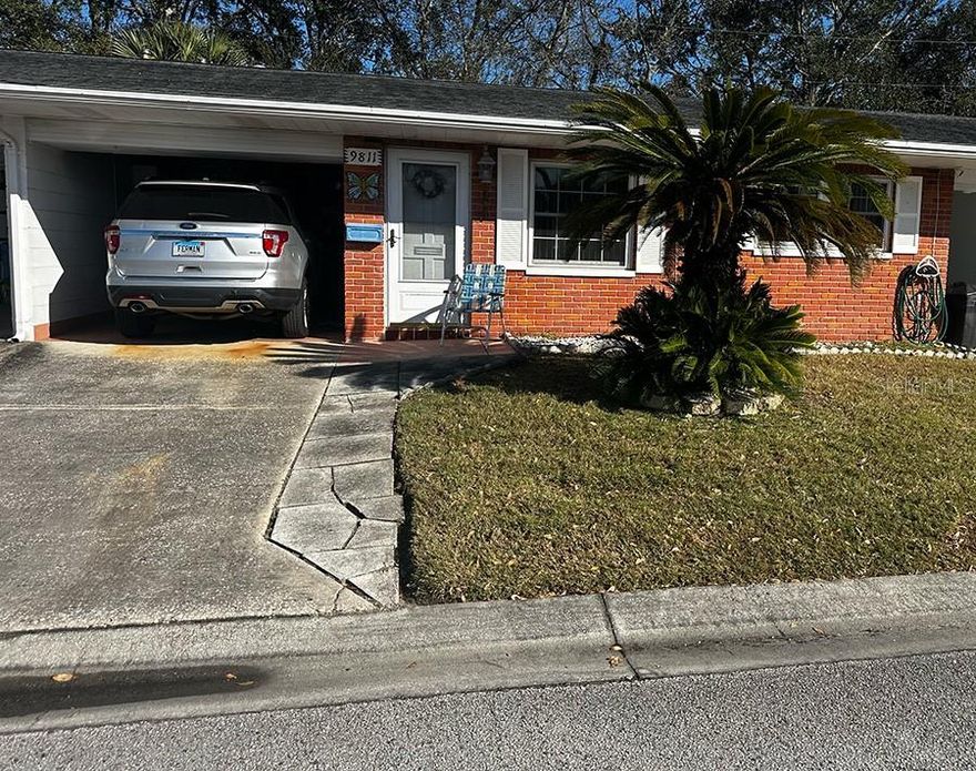 Sun-filled and well-maintained unit featuring inviting living areas that flow from the living room into the dining area and a cozy bonus space with sliding glass doors leading out to the patio — perfect for morning coffee. The bonus space includes a breakfast bar accented by pendant lighting and a built-in china cabinet.  The generously sized primary bedroom offers plenty of room to unwind, while the second bedroom includes a convenient stackable washer and dryer neatly tucked into the closet. Impact windows provide added peace of mind throughout.  Additional highlights include a carport with storage cabinet and a pull-down attic for extra storage. HVAC (3/24), HWH (11/22). Offered furnished for seller’s convenience.  This home is ready for your personal touch. $535/month includes water, sewer, trash, gas, cable, and internet/wifi. Springwood Villa 1 is centrally located near Parkside Mall, restaurants, beaches, Freedom Park, airports, and highways.