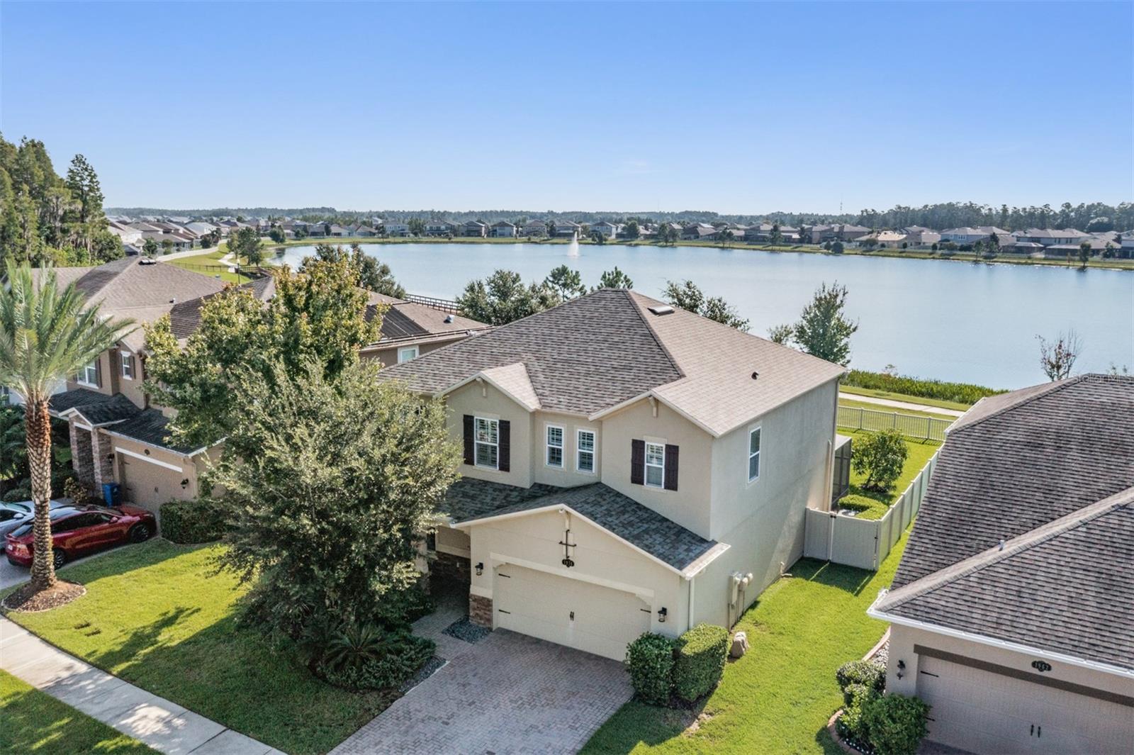 Welcome to this stunning 4-bedroom, 3.5-bathroom home perfectly situated on a beautiful lakefront lot in Long Lake Ranch. From the moment you arrive, you’ll be impressed with the lush landscaping, brick-pavered driveway, and timeless curb appeal.
Step inside to discover an open-concept floor plan filled with natural light, highlighted by triple sliding glass doors and elegant plantation shutters throughout. The formal dining room offers the perfect space for entertaining, while the chef’s kitchen boasts a large center island, double ovens, abundant cabinetry, and extra storage tucked under the stairs. Gorgeous wrought-iron stair railings and upgraded laminate and tile flooring (no carpet!) add style and durability to every room.
The expansive bonus room offers endless possibilities—game room, media room, or home office. Retreat to the huge master suite featuring tray ceilings and a spa-like ensuite. Outdoors, enjoy serene lake views from your large screened-in patio or unwind under the charming pergola in your fenced backyard.
This community is packed with resort-style amenities, including a clubhouse, pool, splash pad, playgrounds, dog park, tennis and basketball courts, fishing dock, and even a kayak launch!
With a brand NEW ROOF and countless upgrades, this home is move-in ready and truly has it all.