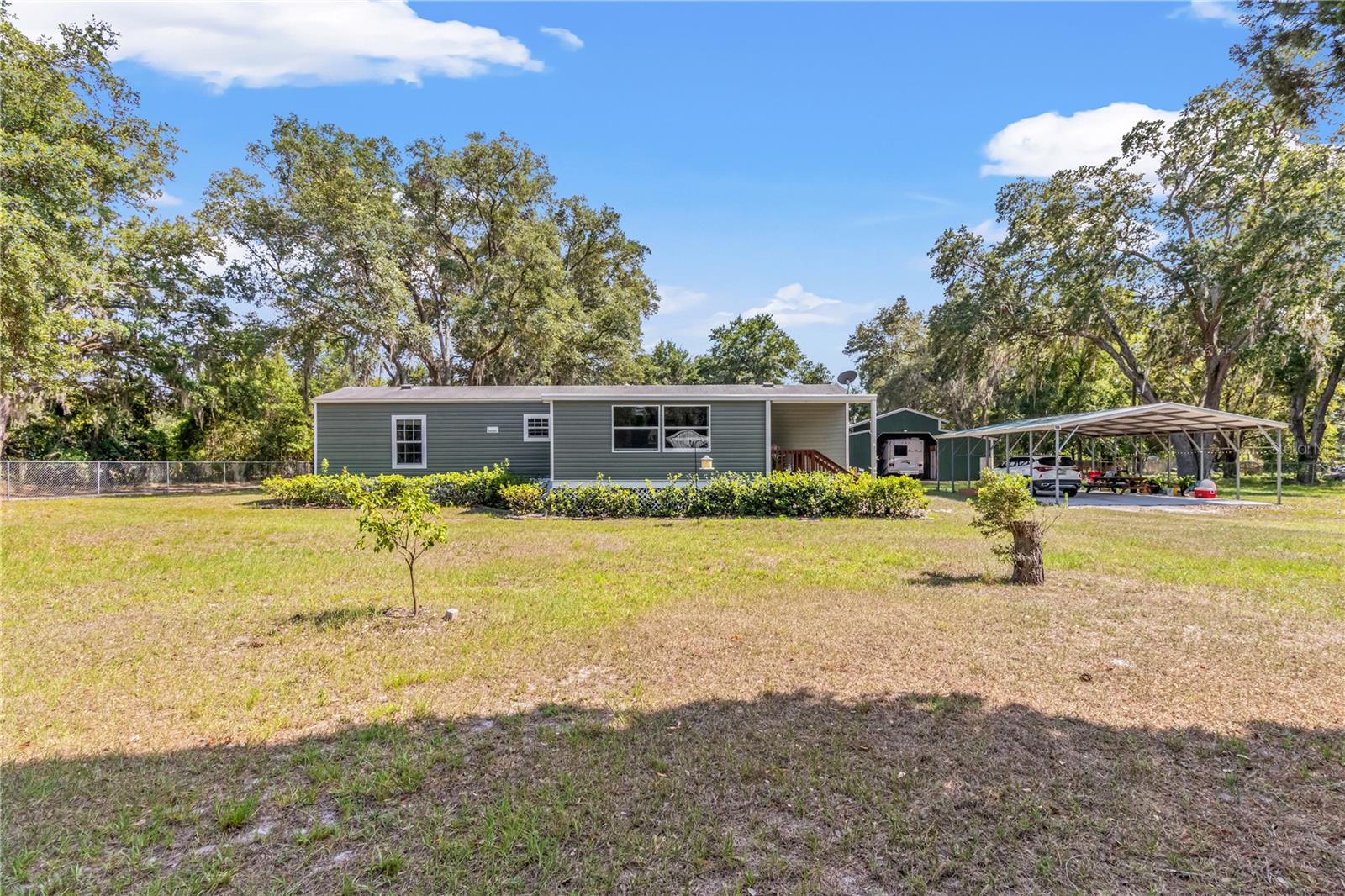 Looking for country living at its finest? You have found it here. This home shows pride of ownership through and through. This, well-kept home offers a slice of country living. This property boasts plenty of space for all your toys and tools. You'll have room to spread out and enjoy this fully fenced 1 acre lot with a large 40' x 24' pole barn that includes a dream workshop attached with a AC wall unit that is perfect while working on your projects. The 24' x 30' paved carport is perfect for multiple cars. This 2015 home is up-to-date with a water softener and a hot water heater that was installed in 2020. The home has 2019 central air. The home has gutters that are covered, to save you the work of cleaning them out. Instead, you'll be able to relax and enjoy your days in the beautiful, serene setting of this home. Sit back, relax and enjoy all that this quiet peaceful home has to offer. Hurry before this opportunity is gone!