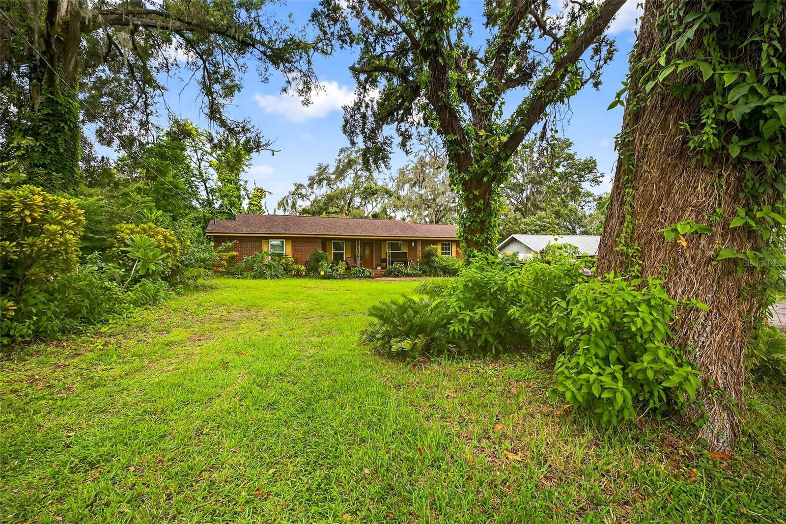 Don’t miss this beautiful home in the heart of Seffner! Situated on an expansive lot of almost ½ an acre with no HOA, this spacious 3-bedroom, 2-bathroom (plus efficiency) property offers both comfort and flexibility. Recent upgrades include a new roof, brand-new AC, windows, and electrical panel—giving you peace of mind for years to come. One of the standout features is the private efficiency suite with its own separate entrance, perfect for in-laws, guests, or potential rental income. Inside, you’ll find warm wood floors, a cozy living and dining space, and a kitchen that overlooks the lush backyard. The outdoor area is a true retreat with beautiful landscaping, mature trees, fruit trees, and plenty of space to relax, garden, or entertain. Whether you're looking for space to grow or just want a peaceful place to call home, this property offers it all—with charm and character at every turn.