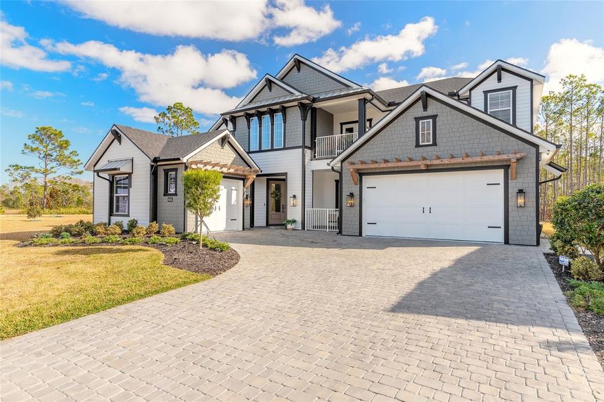 Experience elevated luxury living in this extensively upgraded 5-bedroom, 3.5-bath executive residence offering nearly 4,000 square feet of thoughtfully designed space on a 70x142 homesite in Port Orange. From the moment you enter the grand foyer, you are welcomed by a warm, refined color palette and an elegant staircase that sets the tone for the sophistication found throughout. Built with over $300,000 in premium builder upgrades, this two-story Brooke floorplan blends timeless design with functional flexibility, ideal for luxury buyers or multi-generational living.
The enhanced layout features a larger eat-in kitchen, a full Butler’s pantry that serves as a secondary prep kitchen, and multiple bedroom suites including dual primary-style accommodations upstairs and down. For your convenience, there is a washer and dryer both downstairs and upstairs. Expansive windows and soaring ceilings in the main living area flood the home with natural light while seamlessly connecting the kitchen, dining, and living spaces to the outdoor retreat beyond. Preserve views create a peaceful backdrop and enhance the true indoor-outdoor living experience. A private second-floor balcony offers an additional space to unwind and enjoy quiet mornings or relaxing evenings.
Designer finishes elevate every room, including stained ceiling beams in the dining area, custom wood trim feature walls, shiplap accents, upgraded interior doors, and luxury vinyl plank flooring throughout the primary living areas and bedrooms. The gourmet kitchen is a showpiece with upgraded Level 2 deluxe cabinetry with crown molding, a fully wrapped island with decorative end panels, quartz countertops, wood hood, pot filler, expanded refrigerator bump-out, custom pantry cabinetry, and premium hardware. Quartz surfaces continue throughout all bathrooms, complemented by upgraded cabinetry, floating vanities, designer plumbing fixtures, rain shower heads, handheld shower systems, and elevated tile selections.
The main-level primary suite is both spacious and serene, offering a spa-inspired bath complete with a freestanding soaking tub, expansive walk-in shower, and dual vanities designed for comfort and luxury.
Outdoor living truly sets this home apart. The all-weather covered entertainment area includes a beautifully designed summer kitchen space, gas fireplace, and seasonal motorized shutters for year-round enjoyment. The private pool retreat features a stunning travertine pool deck and wooded preserve backdrop for added privacy. A built-in propane gas fire pit surrounded by an expansive paver patio creates the perfect setting for evening gatherings under the stars.
Situated on a rare cul-de-sac within a gated community, this home also delivers peace of mind with a Honeywell Generac 26kW air-cooled whole-house generator powered by a buried 1,000-gallon propane tank, along with motorized roll-down storm shutters. Smart home features, energy-efficient systems, and a 3-car garage complete this exceptional, move-in-ready executive residence.
All information is intended to be accurate, however not guaranteed.