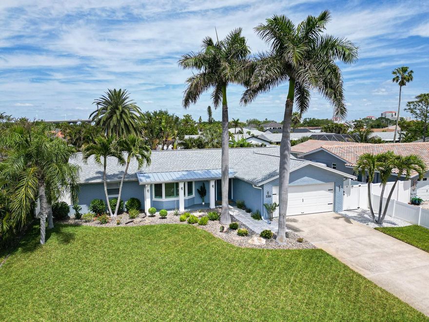 Welcome to Vina del Mar — one of the most prestigious and desirable neighborhoods in St. Pete Beach, where a palm-lined corridor along Pass-A-Grille Way sets the tone for a community defined by manicured surroundings and a distinct coastal character that stands apart from every neighboring area. Tucked just behind Pass-a-Grille, consistently ranked among the best beaches in the United States, this island enclave delivers a rare combination of location, elevation, and lifestyle that cannot be replicated on the barrier islands. Rare opportunity to own a truly turnkey block construction pool home in one of the neighborhood's most sought-after pockets. This 2-bedroom, 2-bath residence with a true bonus room delivers square footage that rivals — and often exceeds — neighboring 3- and 4-bedroom listings, with a bedroom-sized flex space off the primary suite ideal as a home office, guest suite, or private retreat. A bright sunroom adds flexible living space bathed in natural light. Situated in the section of Vina del Mar served by underground utilities, the solid block construction and quality infrastructure represent exactly the kind of foundation today's Florida buyer is looking for. The open/split floor plan is anchored by driftwood-style porcelain tile flooring, custom interior doors blending clean lines with subtle dimension for a modern-coastal aesthetic, frosted glass panel pocket doors, and plantation shutters. The fully remodeled kitchen is the heart of the home: quartz countertops, all-wood cabinetry with soft-close drawers, a pantry with pull-out shelving, KitchenAid appliances, wine storage, and a showstopping 100-year-old cypress beam — a one-of-a-kind detail you won't find anywhere else. Every room — kitchen, living room, and primary suite — looks out onto the lush, private backyard. Open the doors and the outside simply becomes part of the home. 
Step outside into your homeowner-designed backyard oasis — a sparkling saltwater pool, paver patio, covered outdoor living space, and tropical landscaping with soaring palms and flowering plants, enclosed within a 6-foot privacy fence. The two-car garage features a hurricane-rated door. Curb appeal is polished: paver entry, PVC column wraps with exterior sconces, and manicured landscaping accented with river stone and boulders along the walkway.
Major system upgrades: New roof (2025) · HVAC with all-new ductwork & Air Knight air purification (2017) · Replaced electrical panel (2017) · Hurricane-impact French door (2019) & bay window (2018) · A.O. Smith whole-house water softener & filtration system (2022) · Pool pump (2024) · Water heater (2020) · Newly installed Pebble-finish saltwater pool (2017). Additional updates include a Rainbird irrigation system, gutters with gutter guards, underground downspout drains, soffit and fascia, and Nest smart home devices — complete upgrade history available upon request.
 This golf cart-friendly neighborhood sits moments from pickleball courts, tennis, a dog park, playground, and shaded walking paths. Gulf beaches are minutes away. Downtown St. Pete and Tampa Airport are an easy drive. Primary residence, second home, or investment property near the beach — this home checks every box. Extensively updated. Solid block construction. Underground utilities. In one of St. Pete Beach's most coveted communities. Opportunities like this are rare — schedule your private showing today before someone else does.