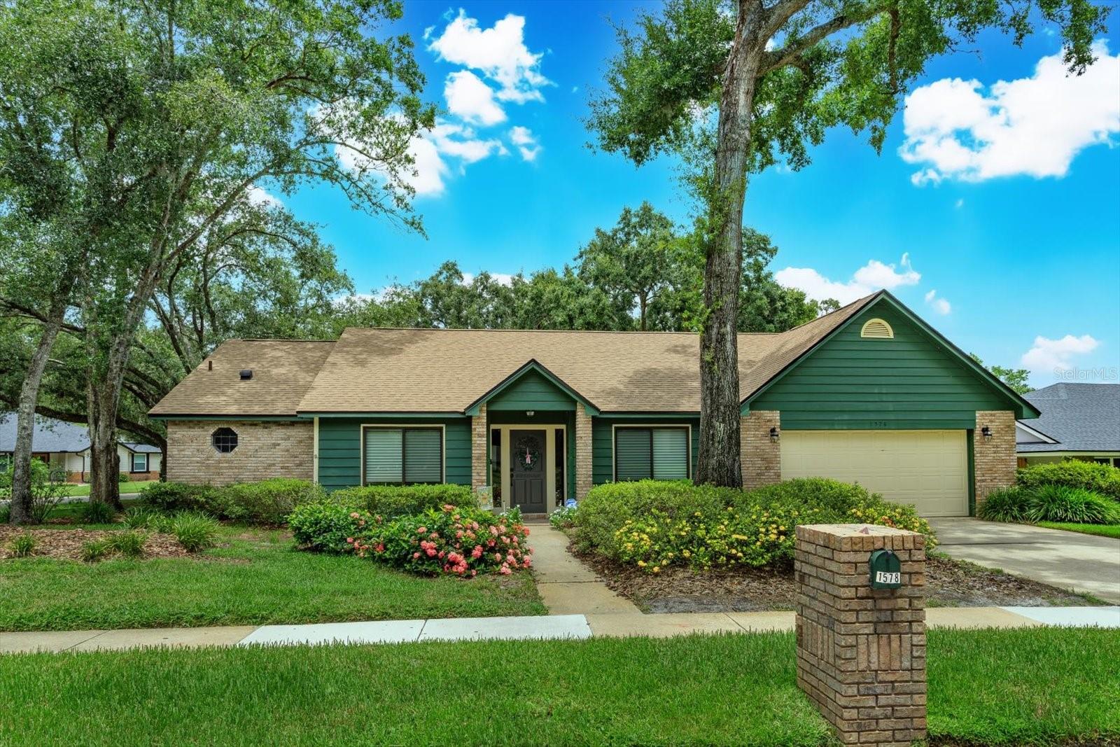 This spacious four-bedroom, two-bathroom home sits on an oversized corner lot in a desirable neighborhood with A-rated schools. The sizable master suite offers a large en suite with double vanity sinks, a walk-in closet, and plenty of space for a private retreat, while three additional large bedrooms provide comfort for family or guests. The home features a generous kitchen with breakfast nook, a formal living and dining room with custom privacy shades, and a welcoming family room with a wood-burning fireplace. A Pella sliding glass door opens to a large screened-in patio overlooking the sparkling pool and expansive backyard, perfect for entertaining or relaxing. Recent upgrades include a new roof in 2021, an AC system installed in 2018 with a new compressor in 2025, Pella windows in the front and rear of the home, and a new garage door opener in 2025 complete with a Wi-Fi camera and Teflon rollers. Conveniently located near shopping, dining, and I-4, with easy access to the back gate of Woodlands Elementary School, this home offers the perfect combination of comfort, style, and location.
